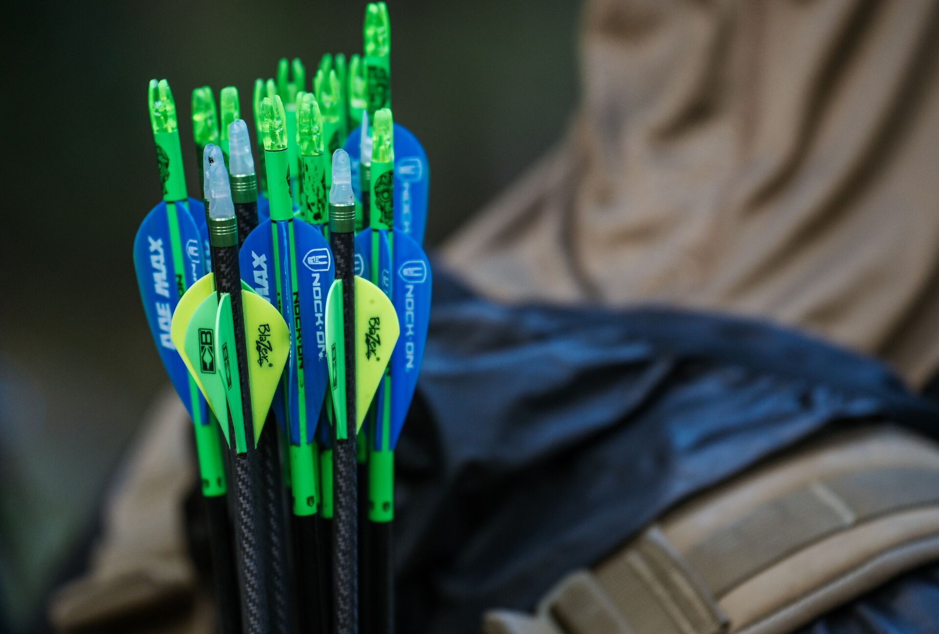 Close-up of a quiver of arrows on a hunter's back, choosing wooden arrows or carbon concept. 