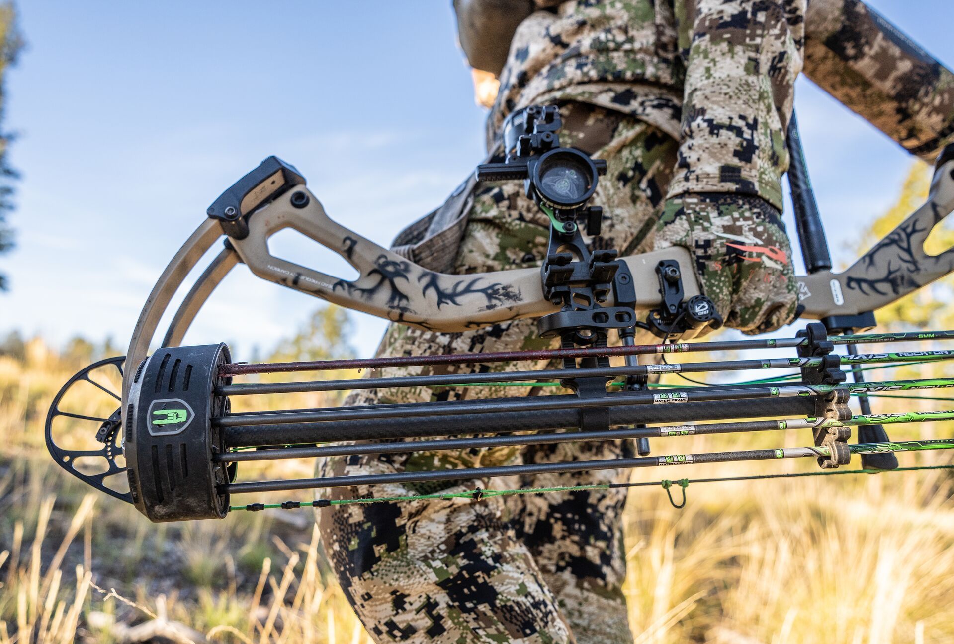 Close-up of a compound bow with arrows held by a hunter's side, are wooden arrows best concept. 