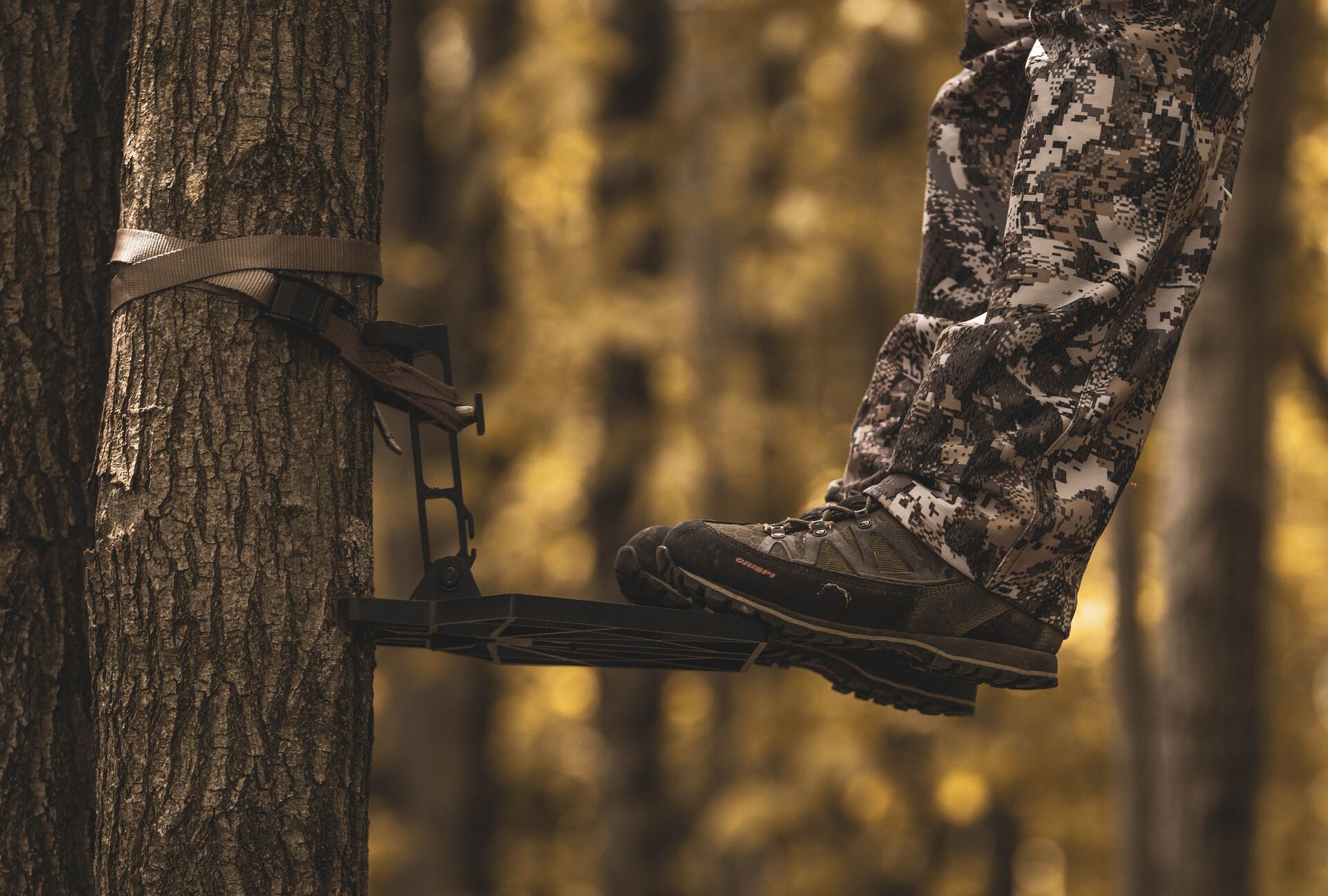 Close-up of a hunter's feet on a tree saddle platform, saddle hunting concept. 