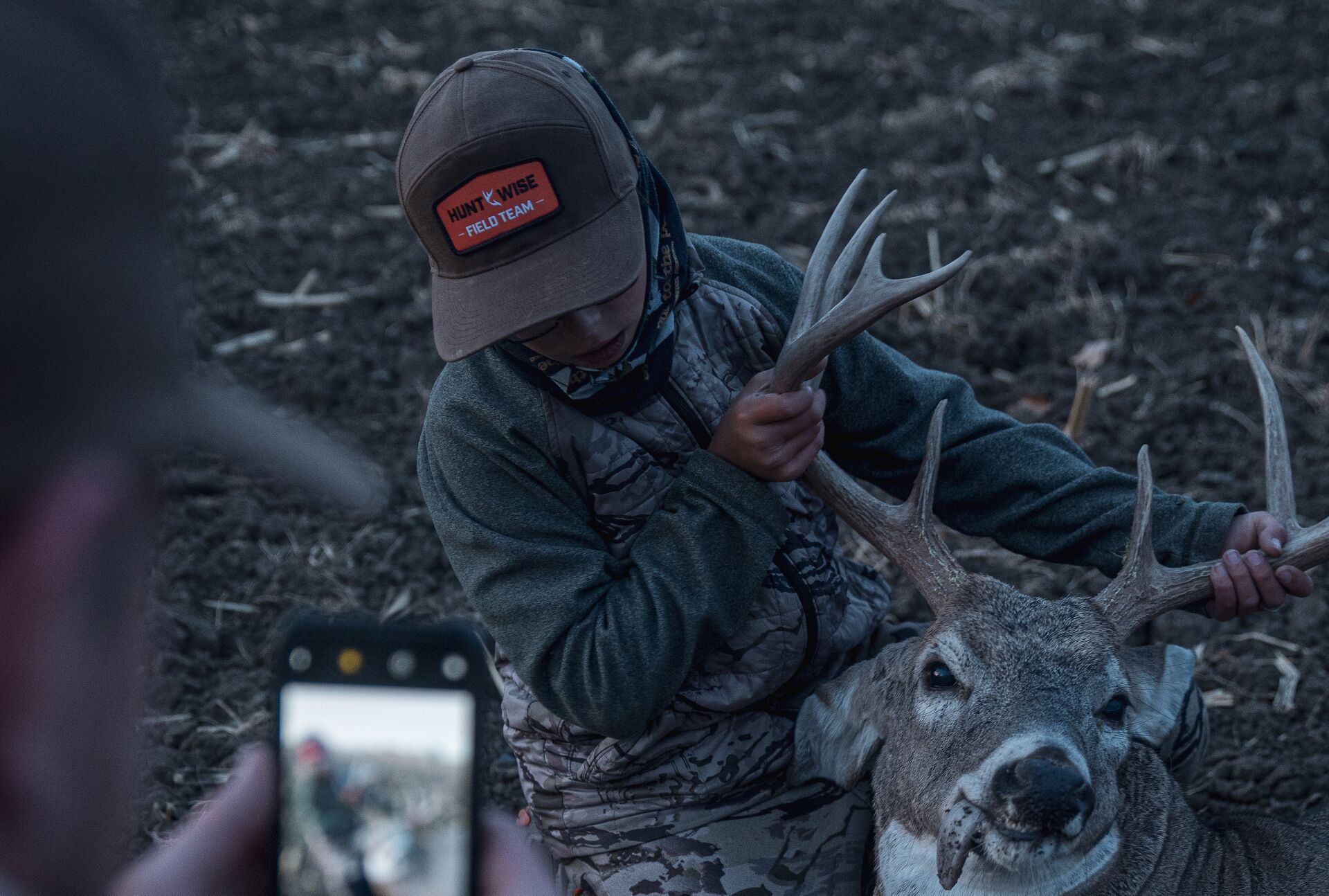 A young hunter has his picture taken with a buck after tagging out, Kentucky hunting concept. 