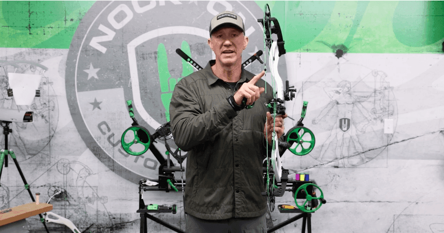John Dudley shows the peep sight of a compound bow. 