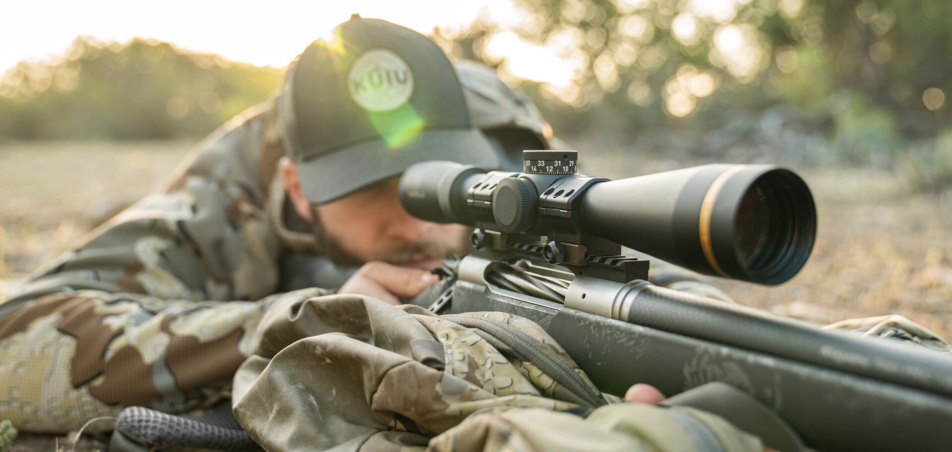Hunter in camo aims rifle, where to shoot a deer with a rifle concept. 
