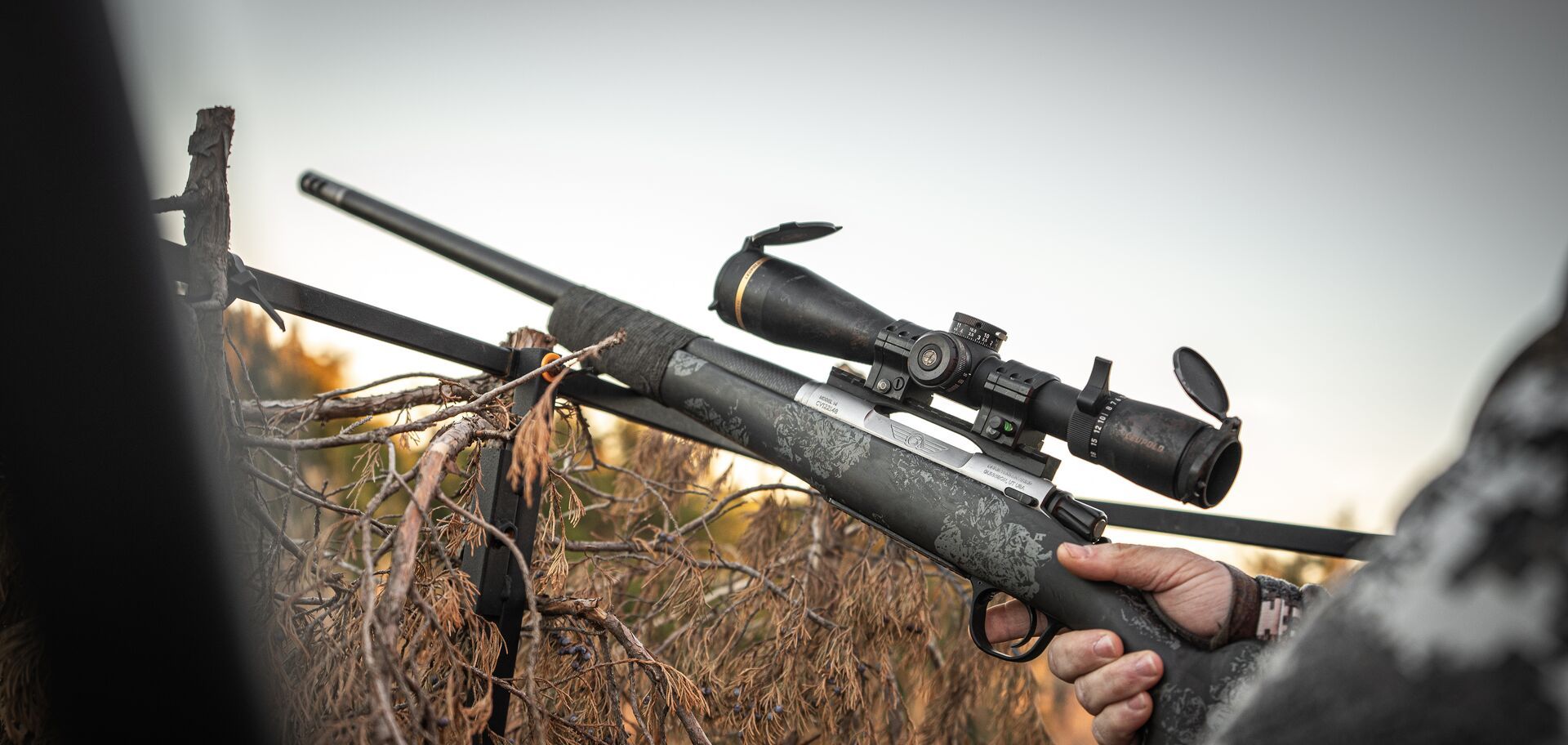 Hunting rifle rests on support. 