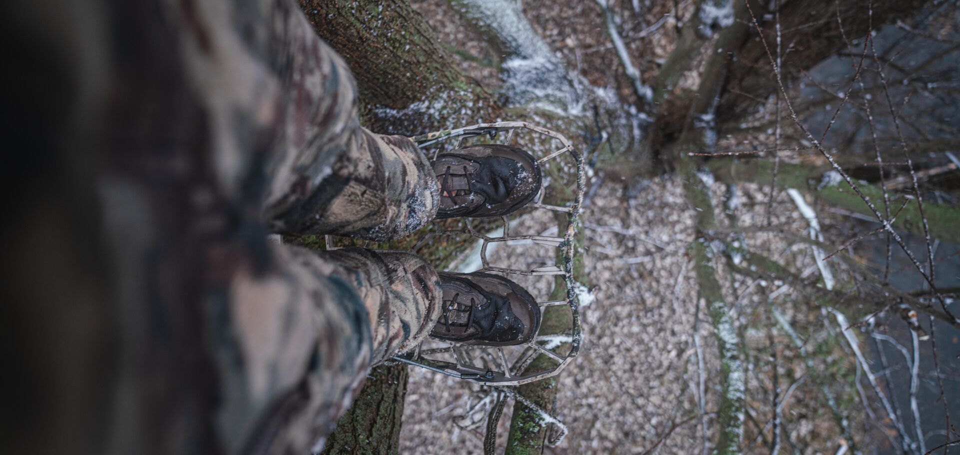View looking down at hunter's boots on tree platform, what to hunt in November concept. 