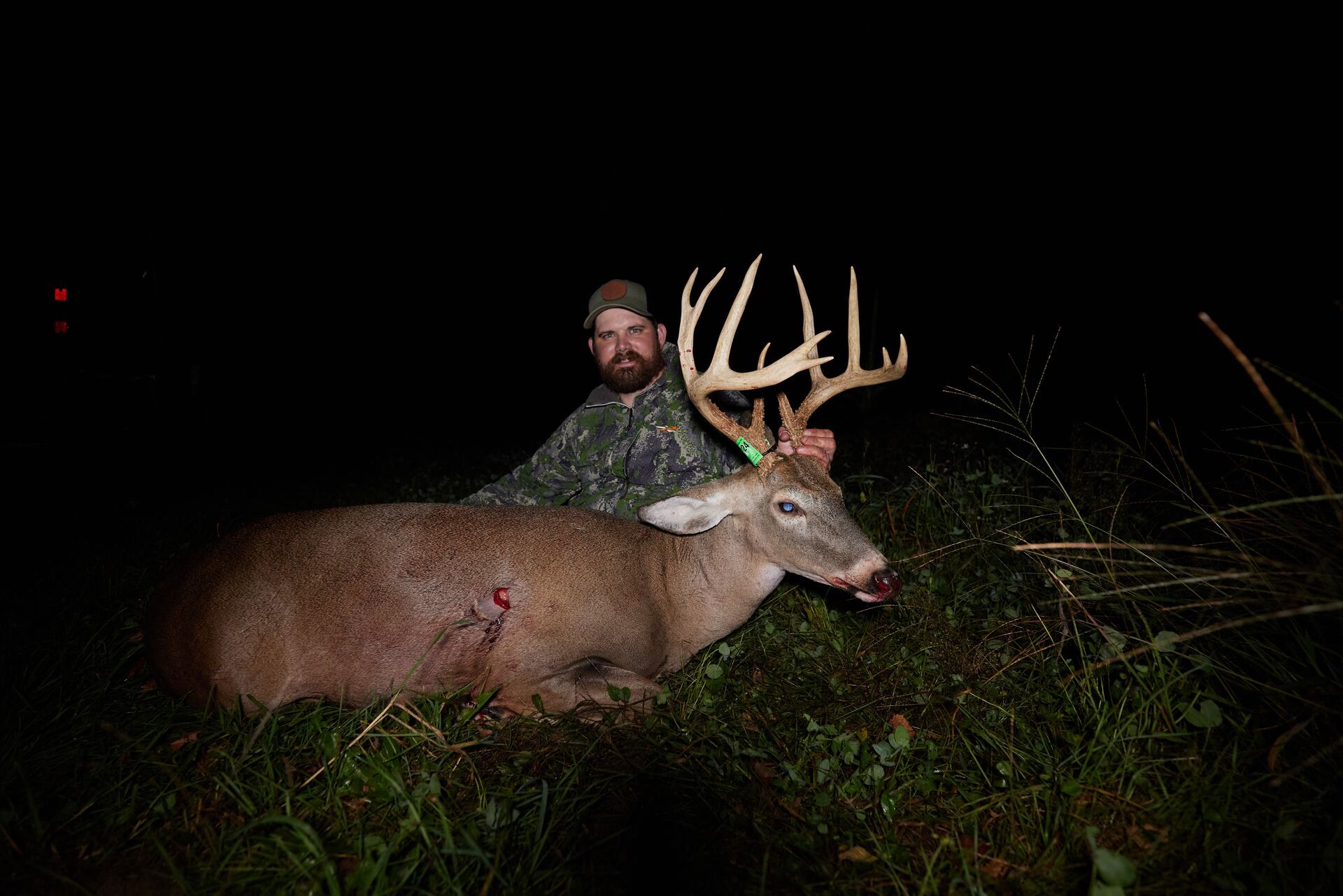 A HuntWise hunter poses with a big buck after a hunt. 