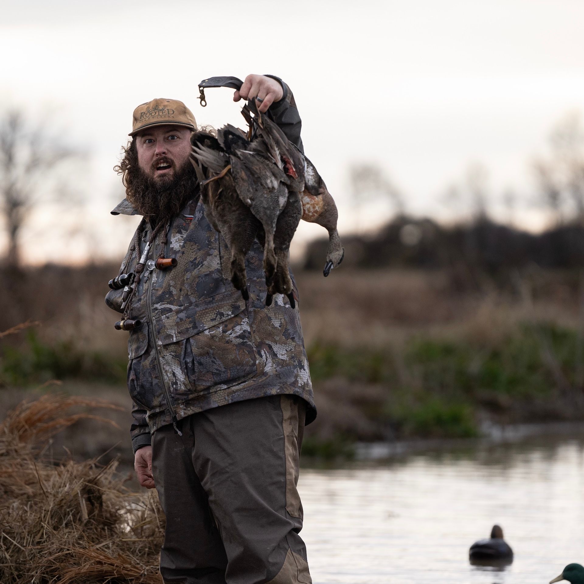 Ben Cole of RootedTV holds up ducks after hunt. 