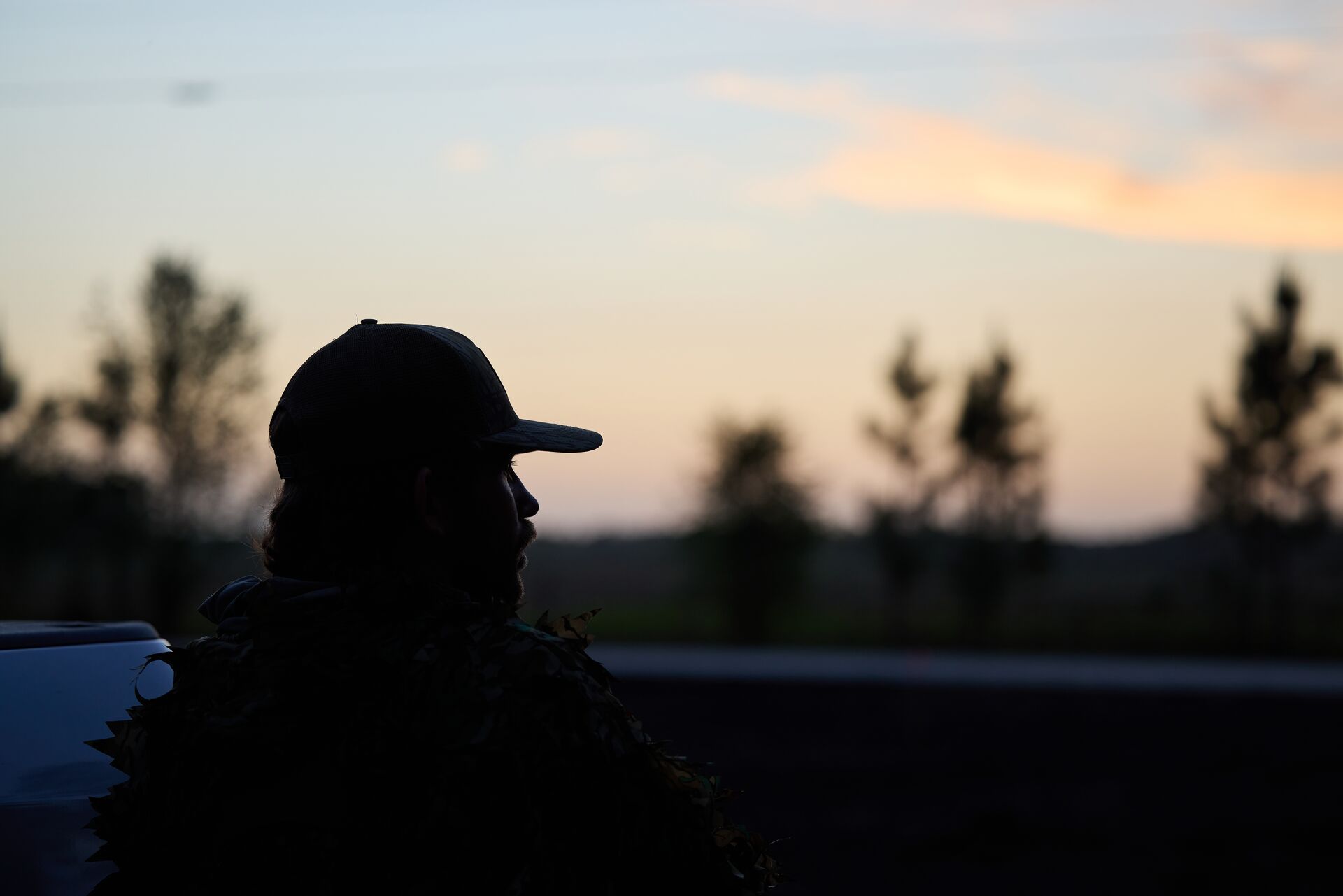 Silhouette of a hunter at early evening, hog hunting at night concept.