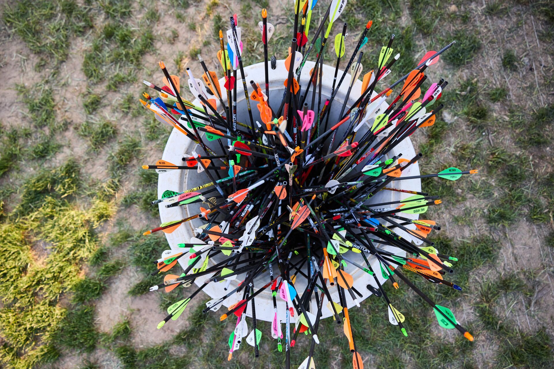 Bucket of different types and colors of arrows. 