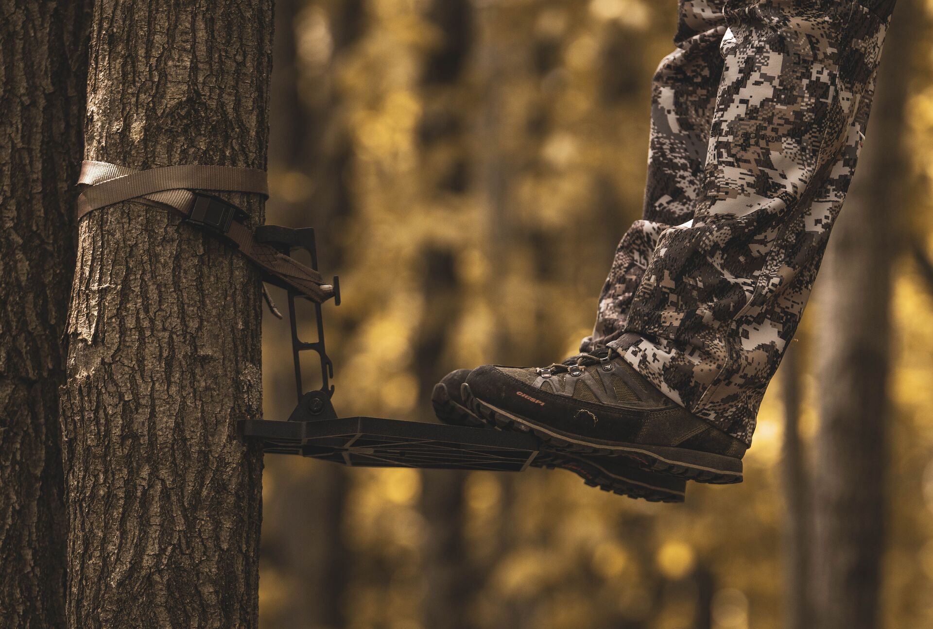 Close-up of a hunter's boots while standing on a tree platform, summer hunting boots concept. 