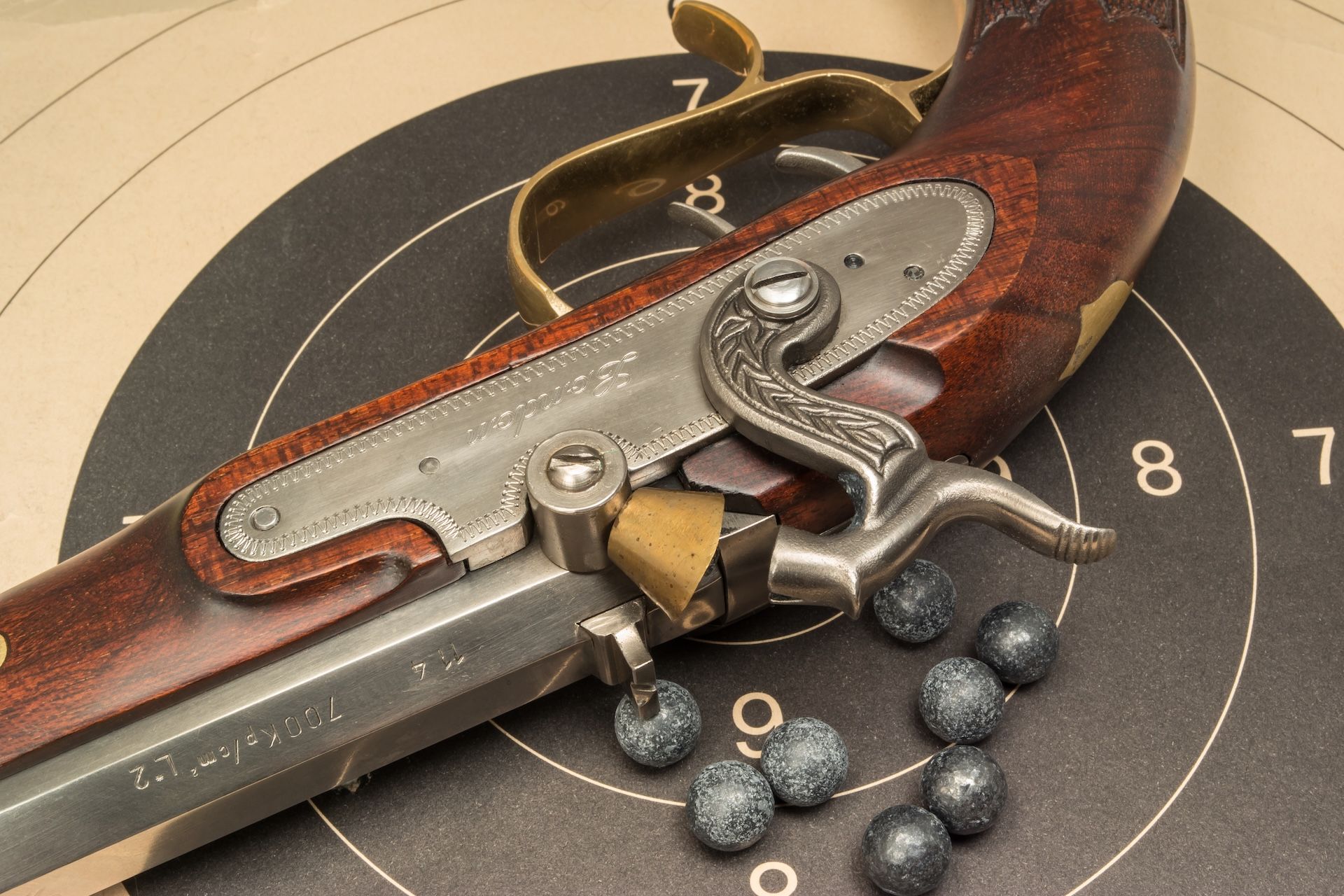 Close-up of muzzleloader hammer with ammo on target, muzzleloader ammo types concept. 
