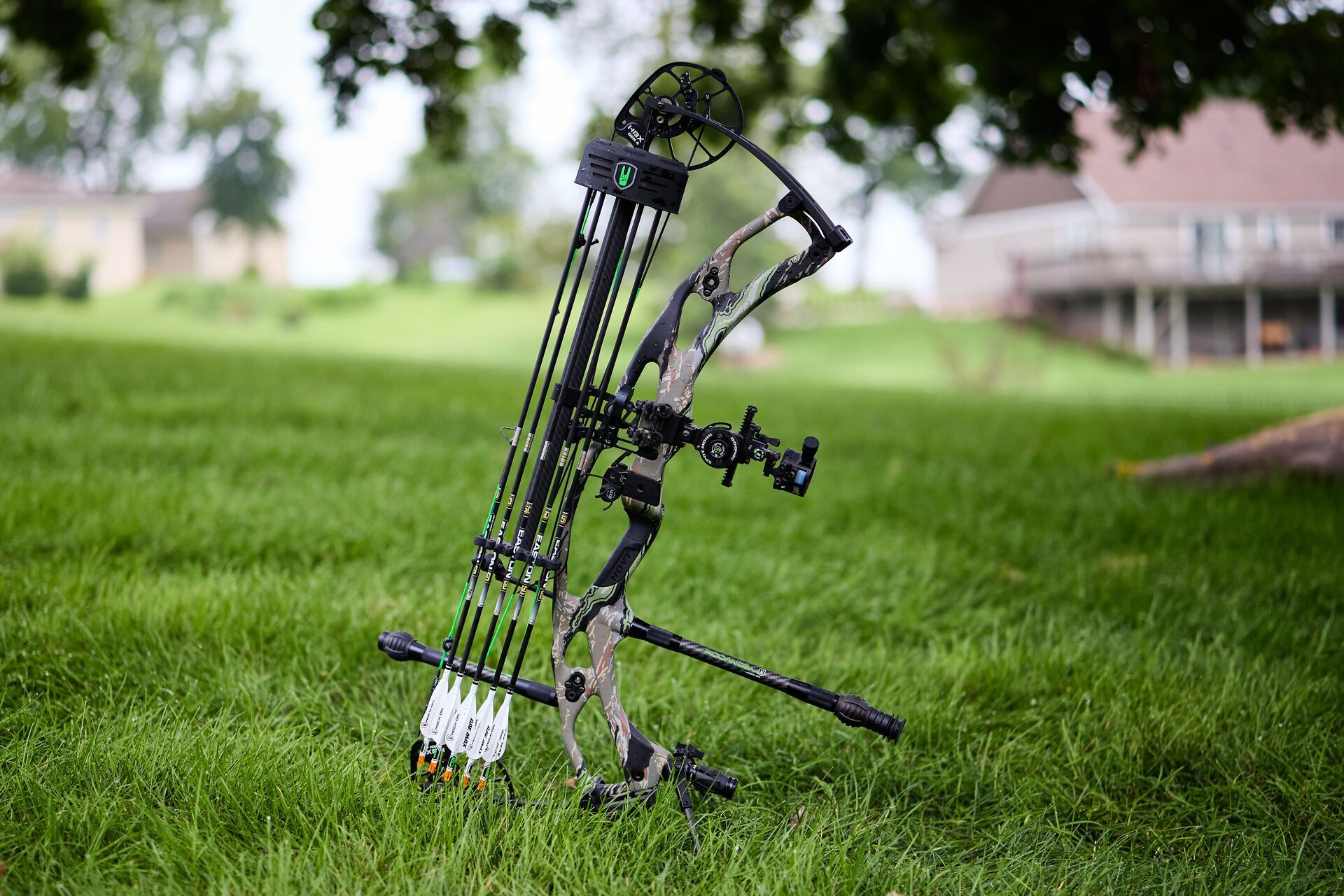 Compound bow propped up in the grass. 