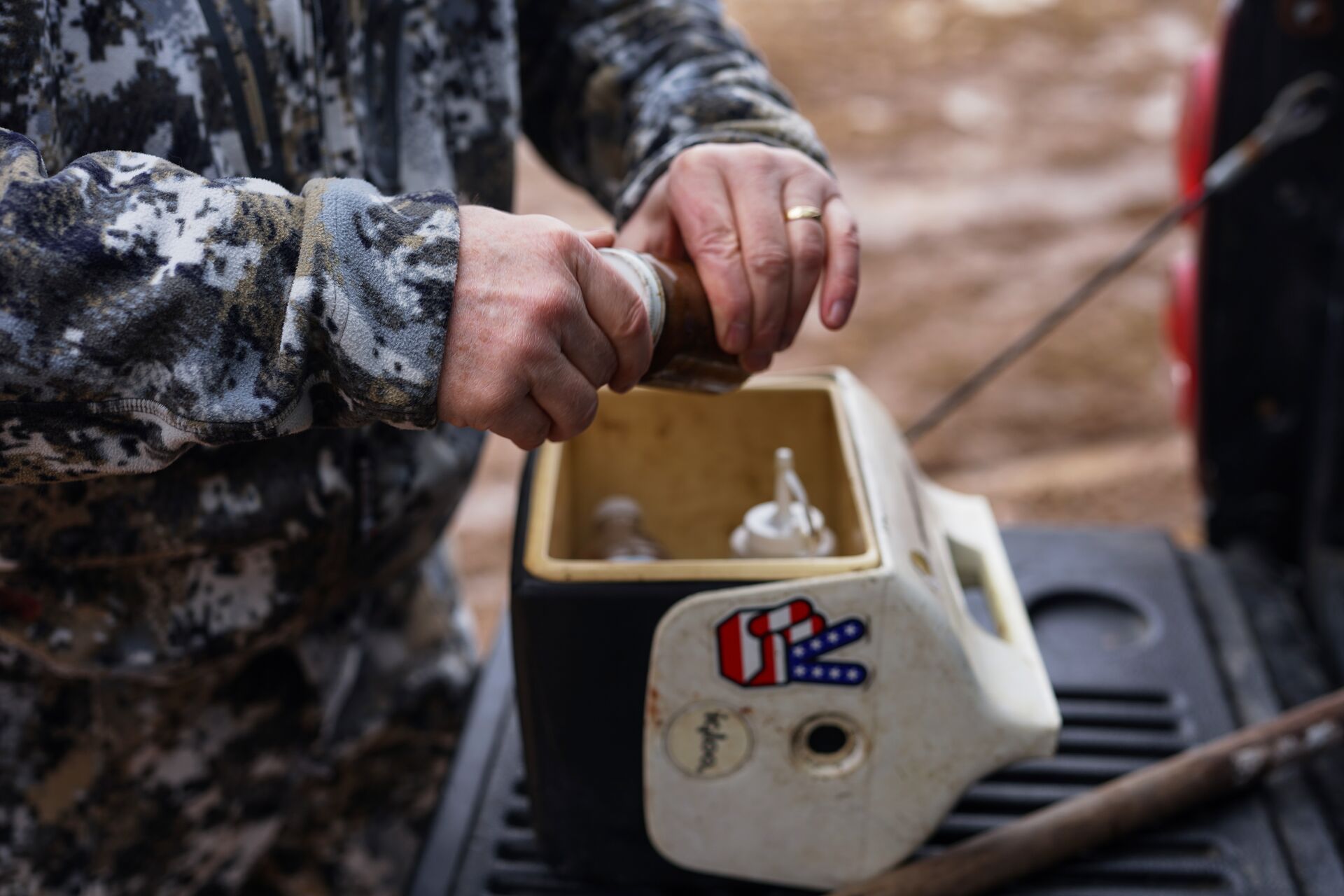 A hunter with animal trapping lure in a cooler. 