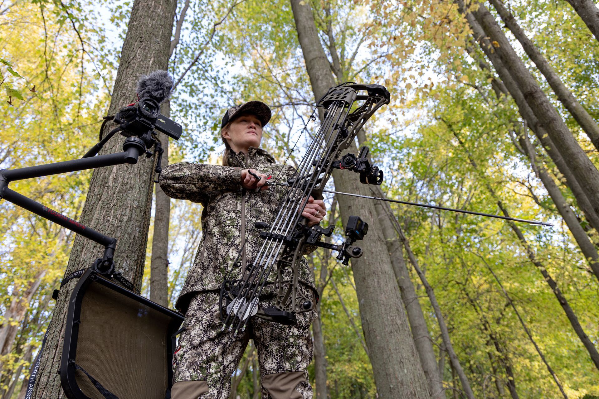 A female hunter with a bow in a tree, what is a broadhead concept. 