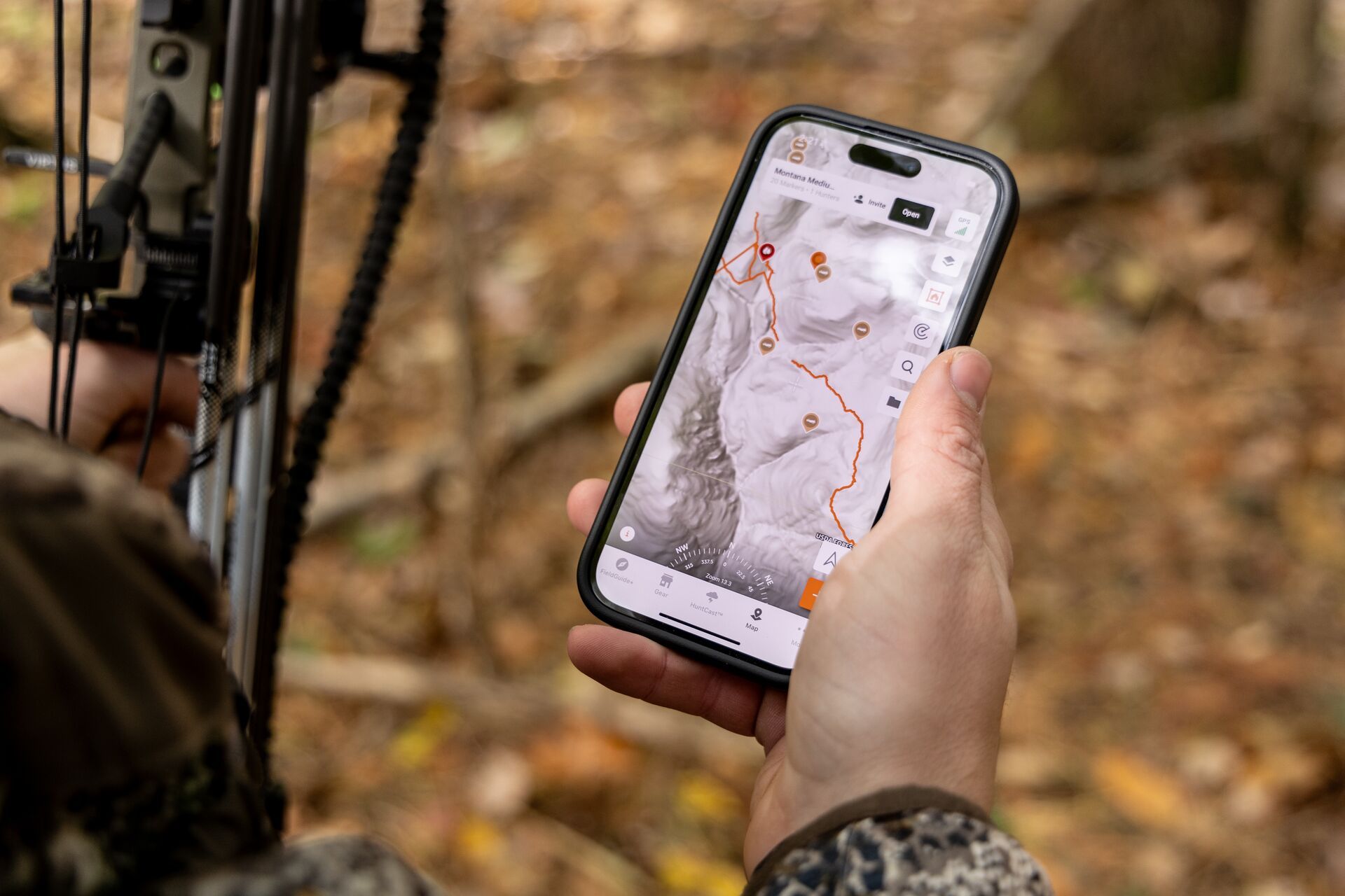 A hunter looks at a LiDAR map in the HuntWise app on a phone screen. 