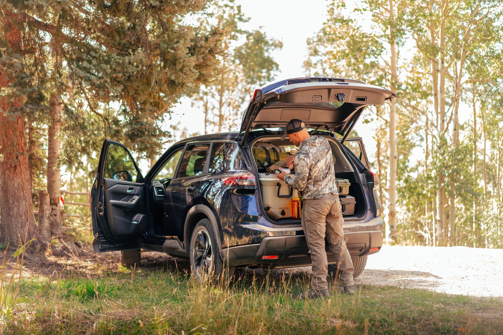 Hunter checking gear in the back of an SUV.