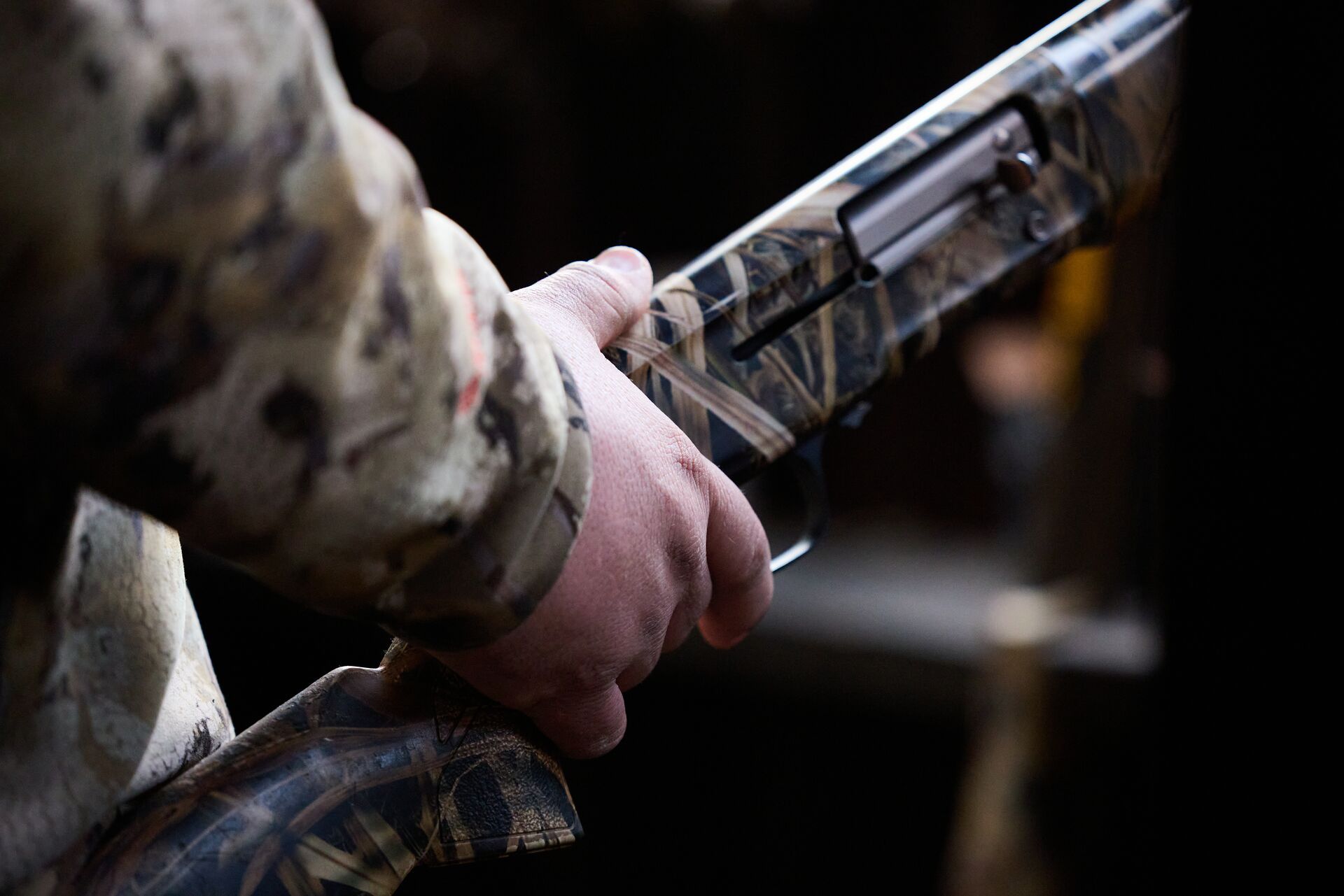 FGBLOG hunter holds camo shotgun.jpeg