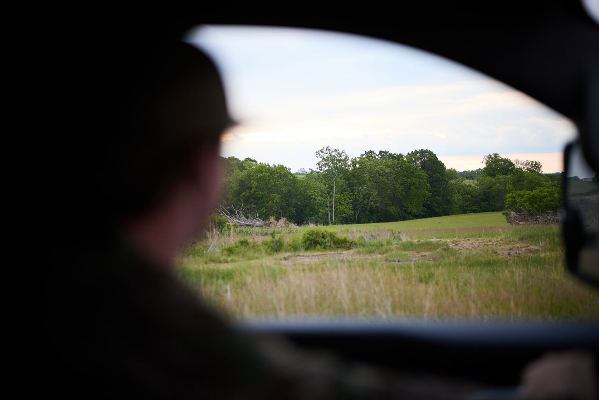 Hunter looks out car window at hunting land, find public hunting land concept.