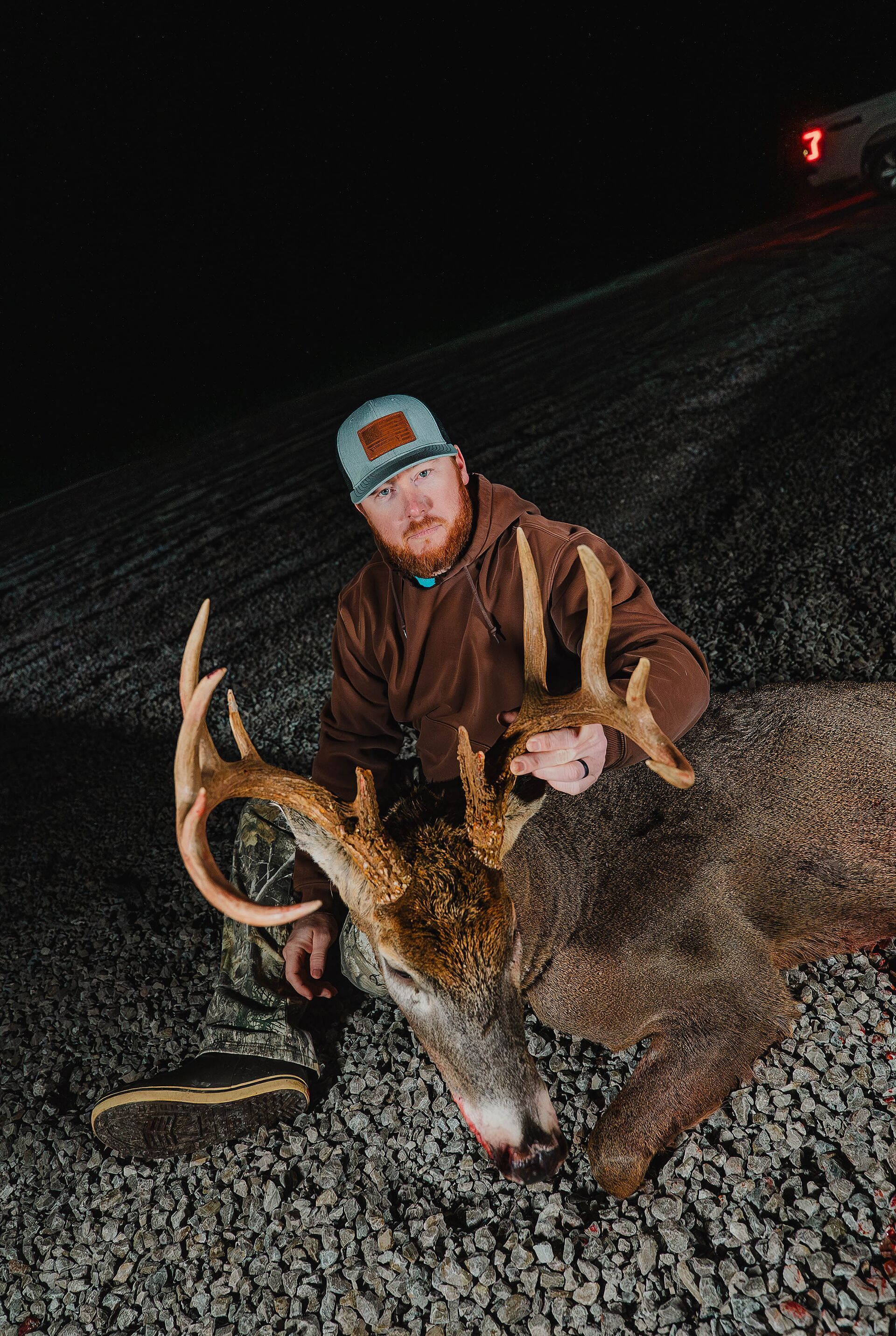 FGBLOG hunter sits with buck deer after hunt.jpeg
