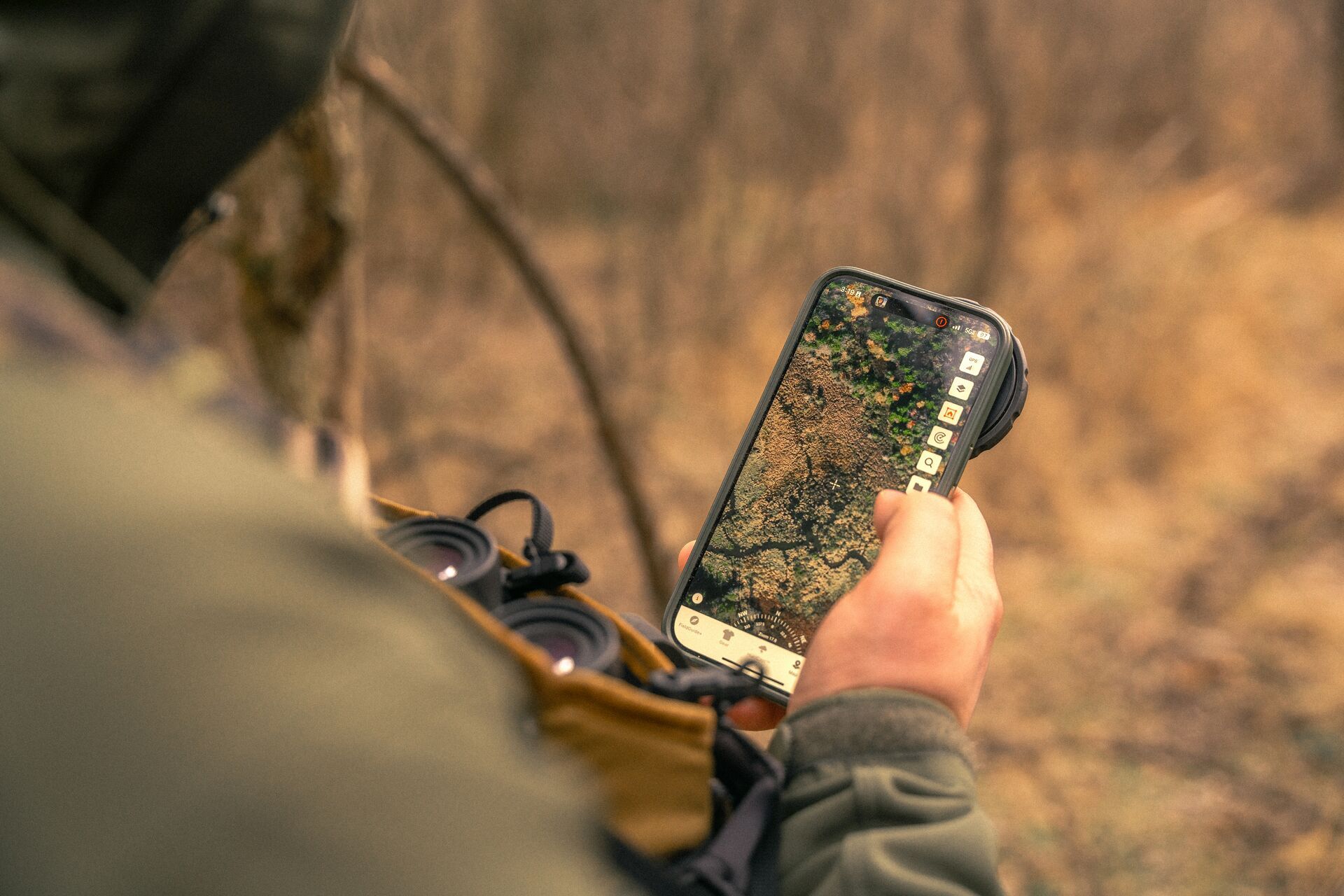 A hunter uses HuntWise on a phone to find a place for a deer watering hole.