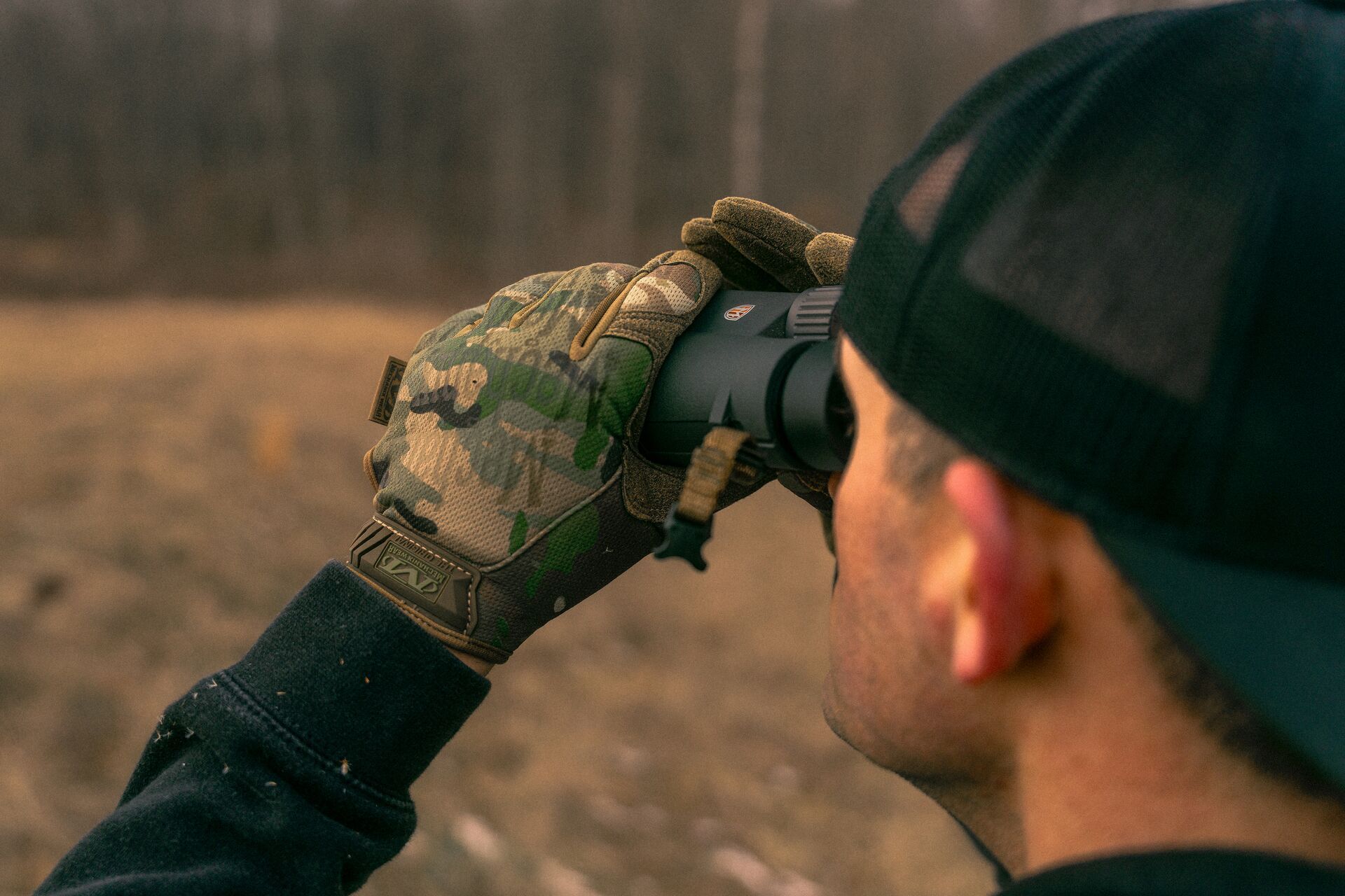 A hunter uses binoculars, best hunting binoculars concept. 