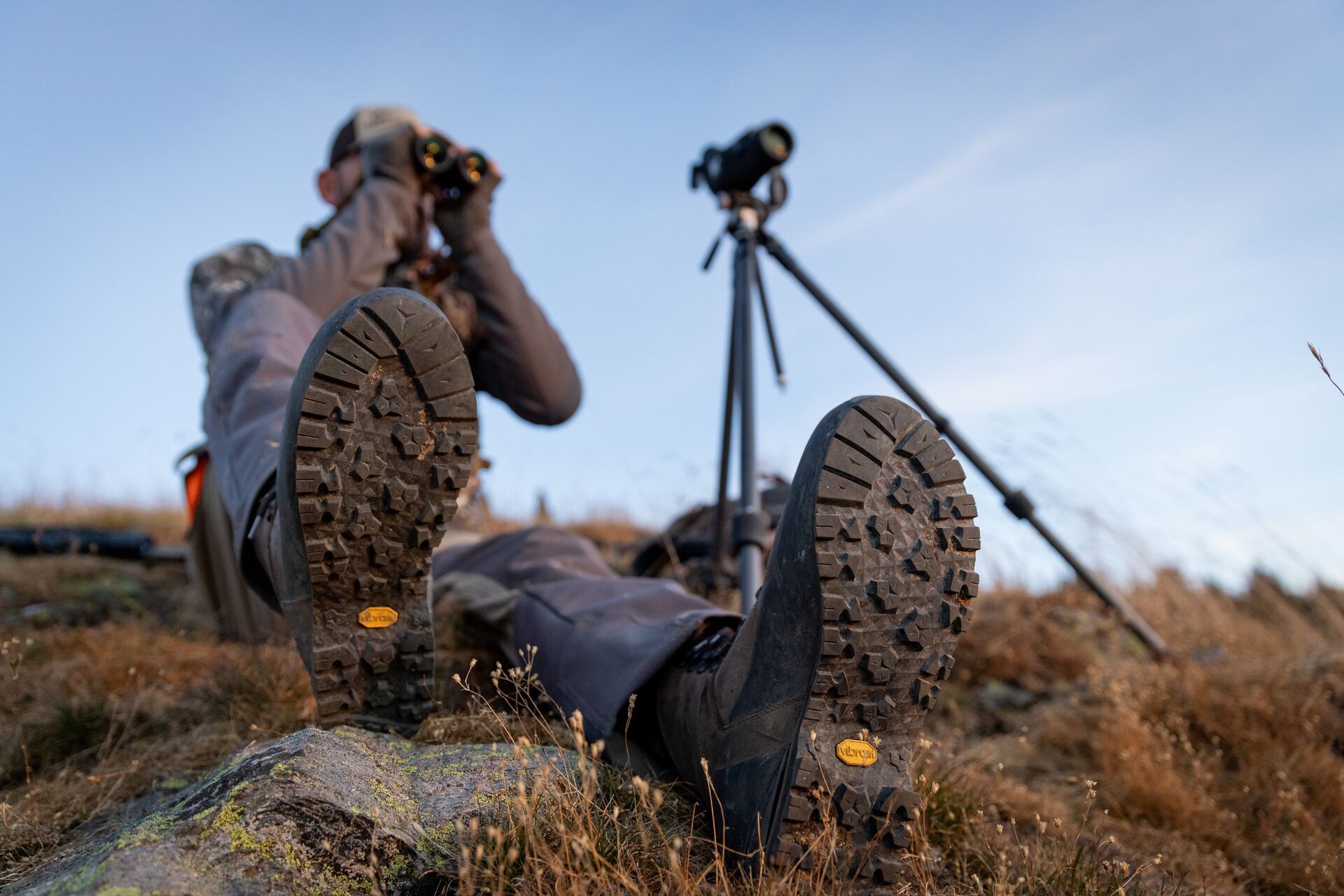 Hunter using binoculars and scope, mule deer scouting tips concept. 