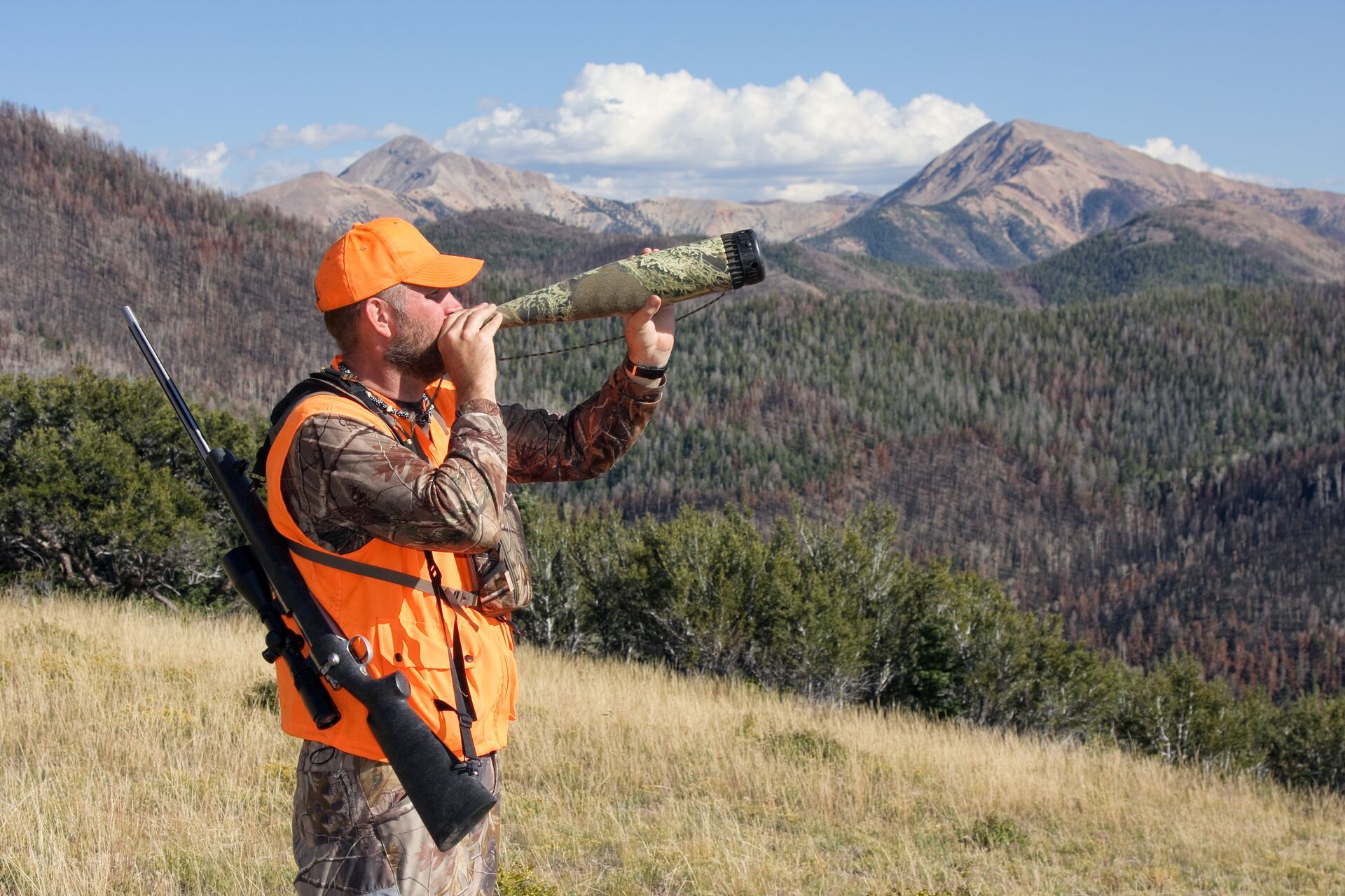 Elk hunter using an elk bugle call, Arizona elk hunting concept. 
