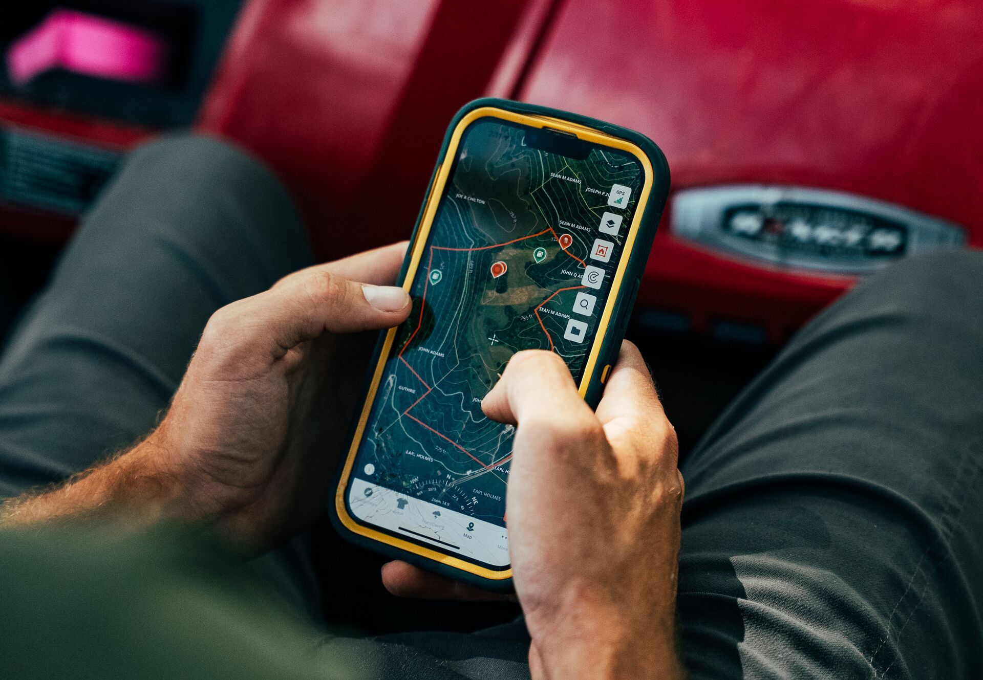 Close-up of someone using phone with HuntWise hunting app on screen.