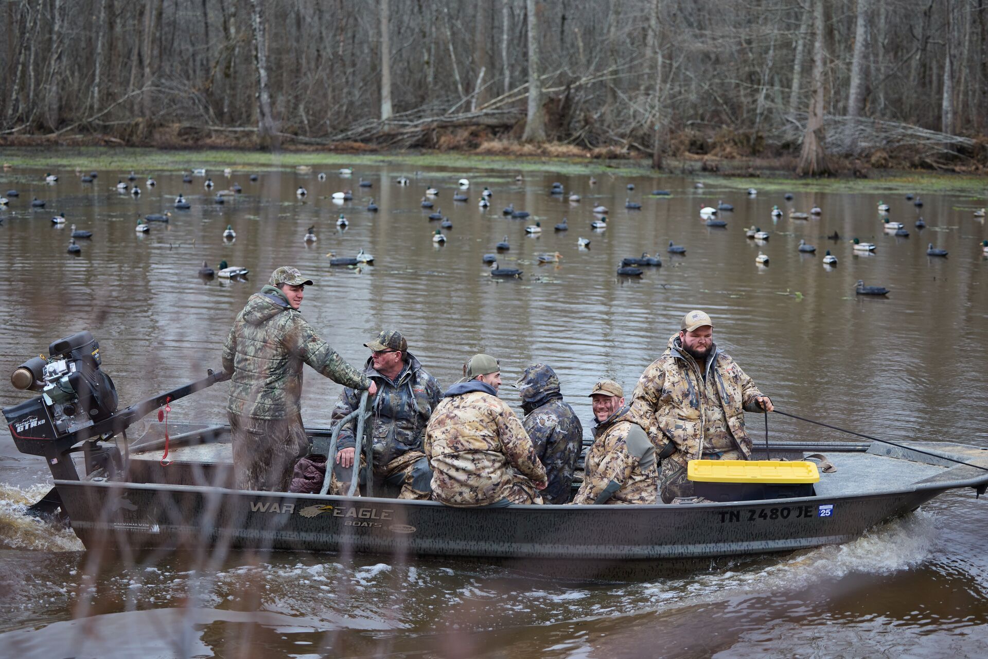 Hunters in a boat on the water for a duck hunt. 