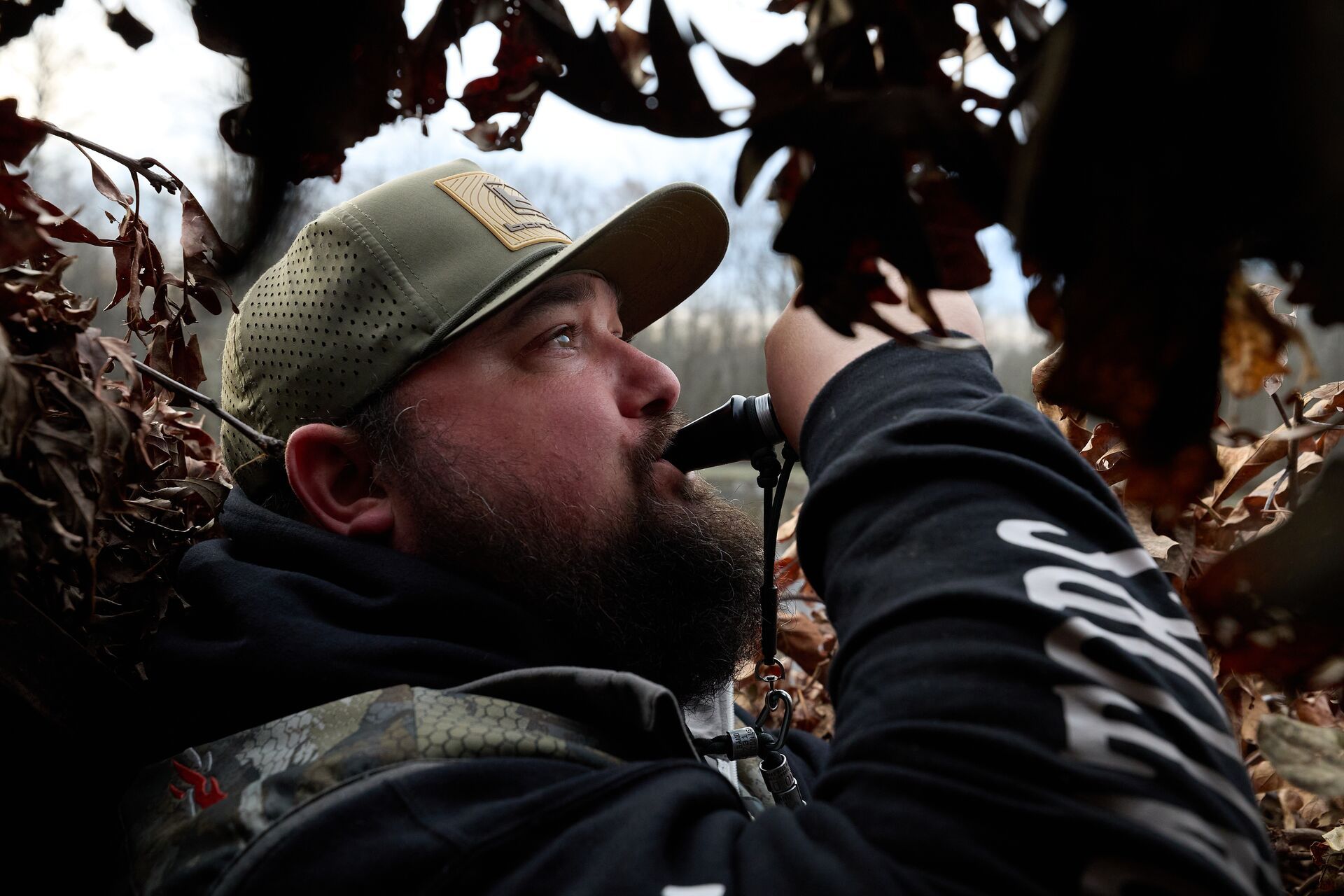 Hunter using duck call, best duck hunting equipment concept. 
