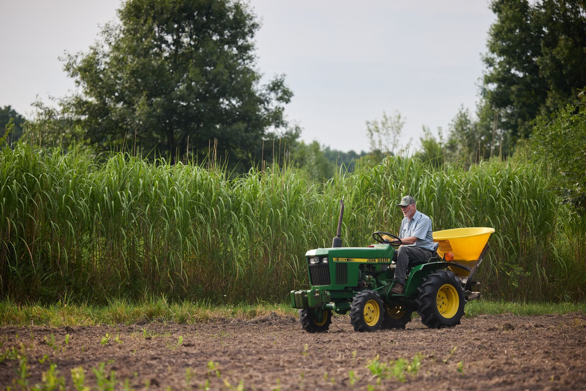 Man driving tractor for food plot.