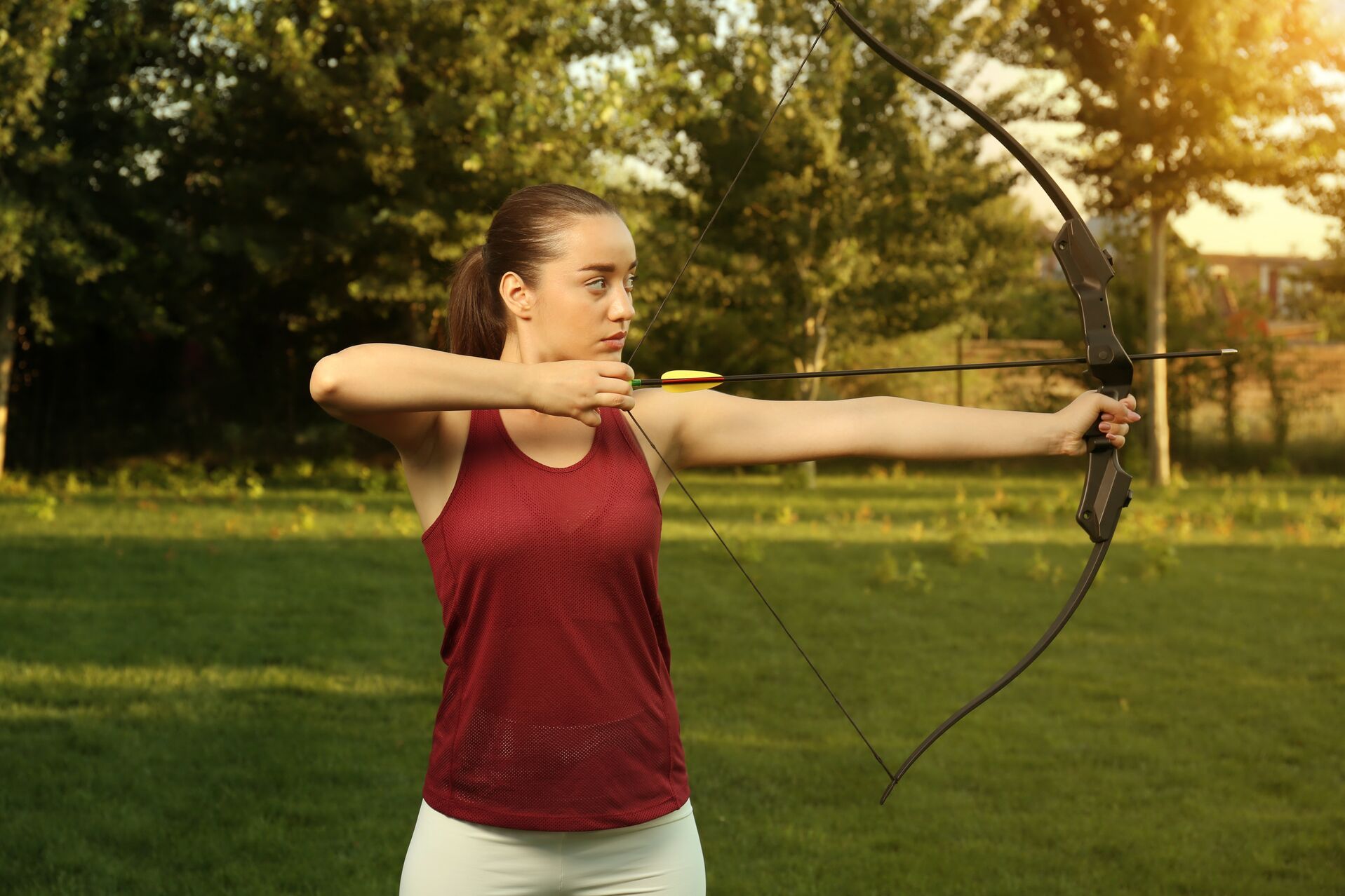 A woman with a recurve bow.