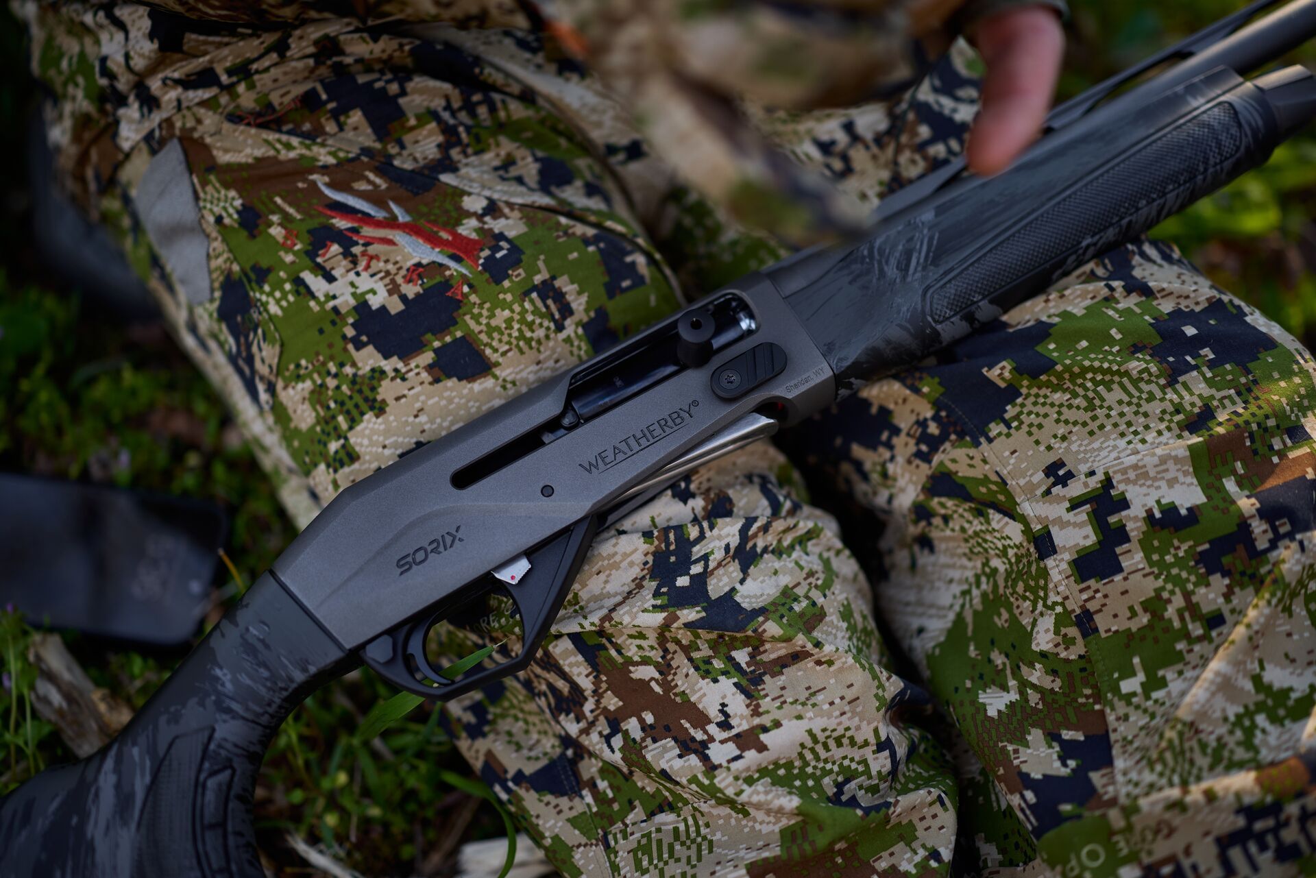 Shotgun for turkey hunting in a hunter's lap.
