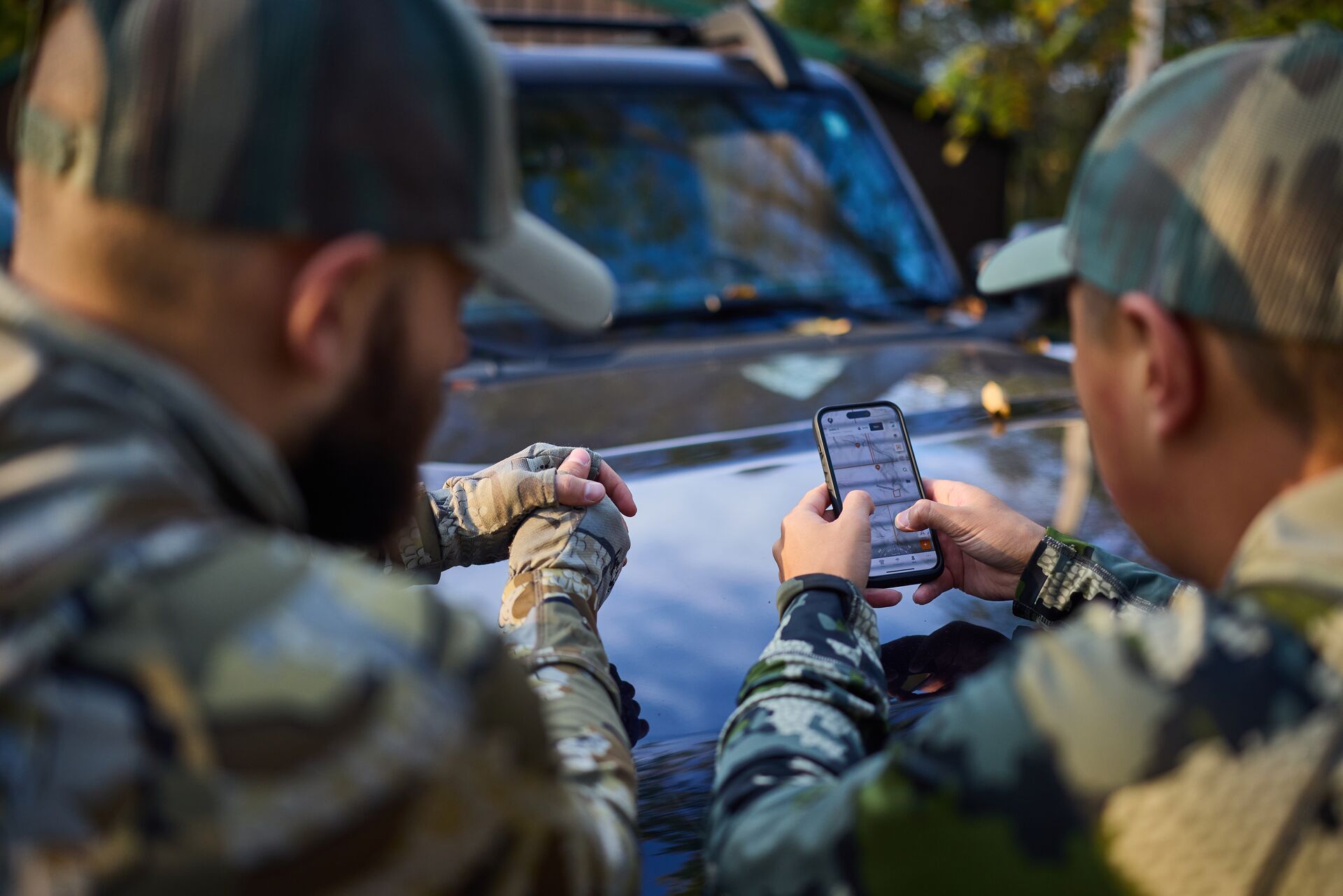 Two hunters using HuntWise maps on phone. 