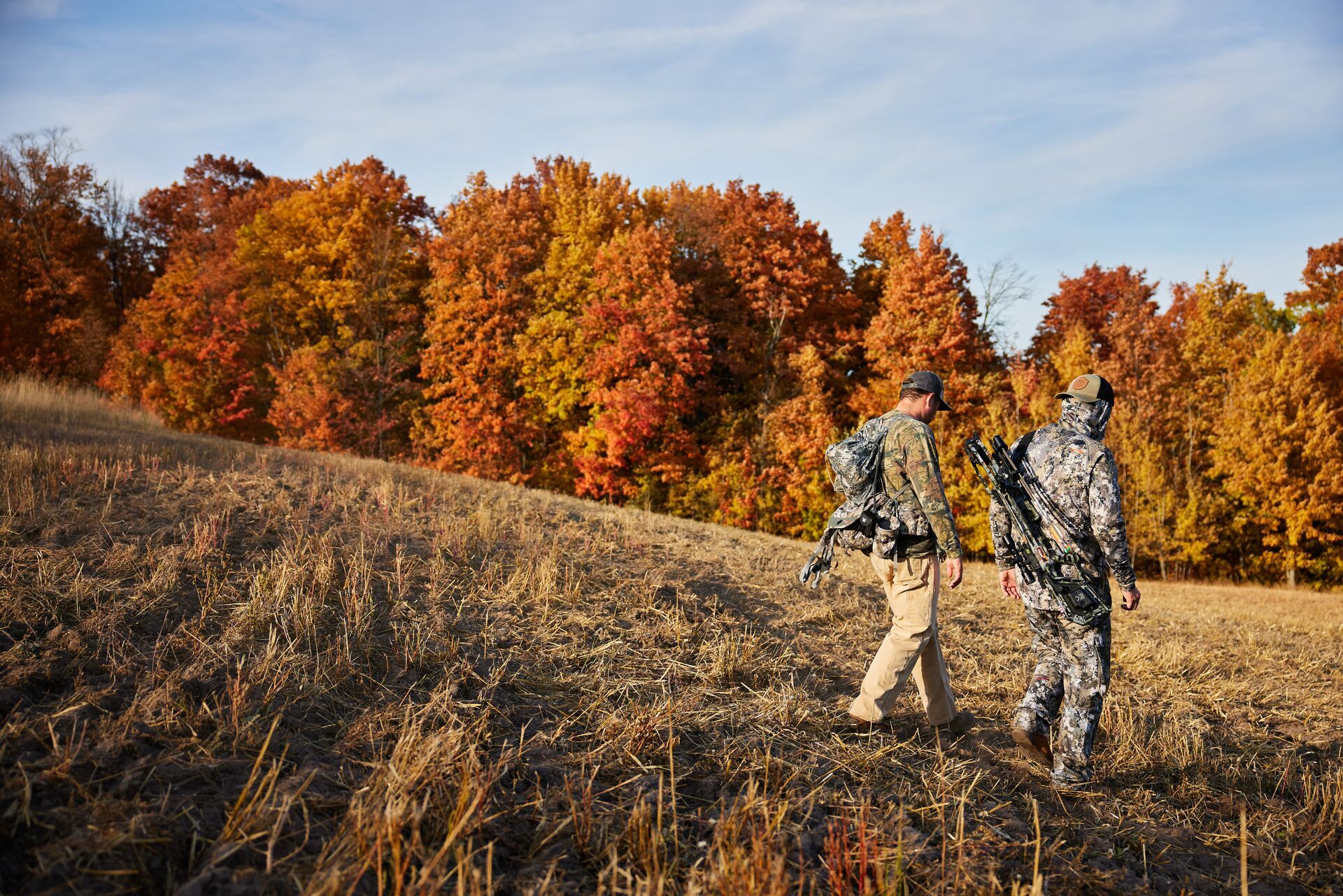 Two hunters walk downhill, how do thermals work in hunting concept. 