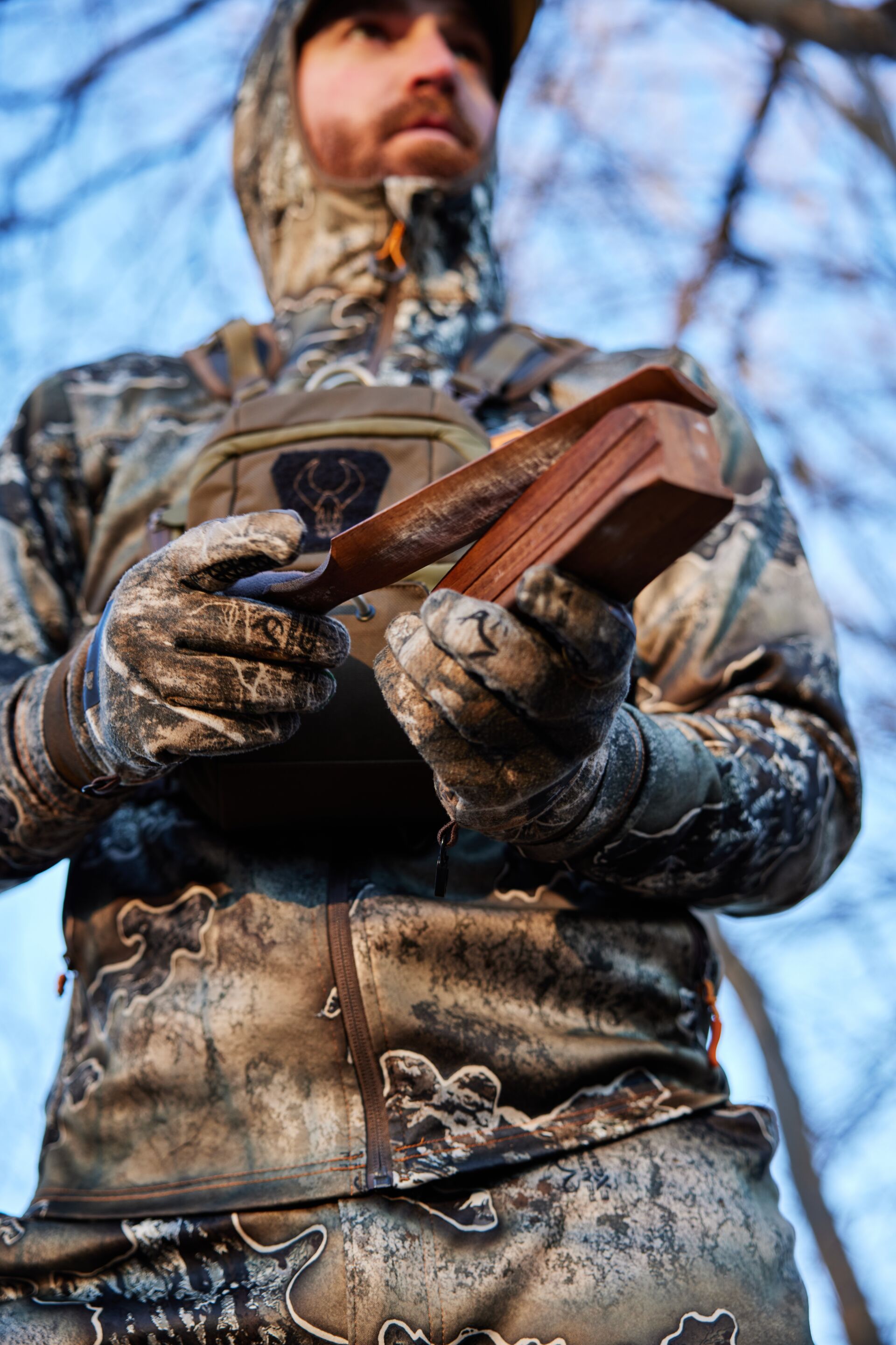 Hunter using a turkey box call, how to call turkeys concept. 
