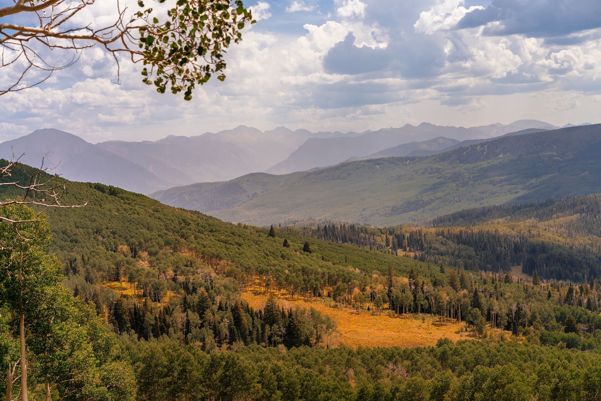 View from a mountain overlooking a valley, represents leave no trace principles. 