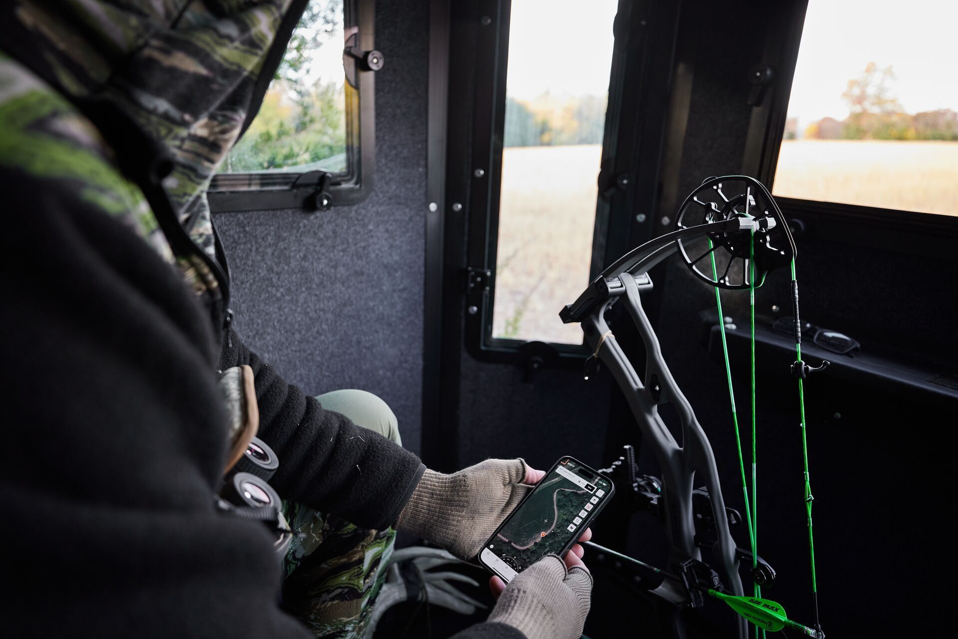 A hunter uses the HuntWise app while in a hunting blind. 