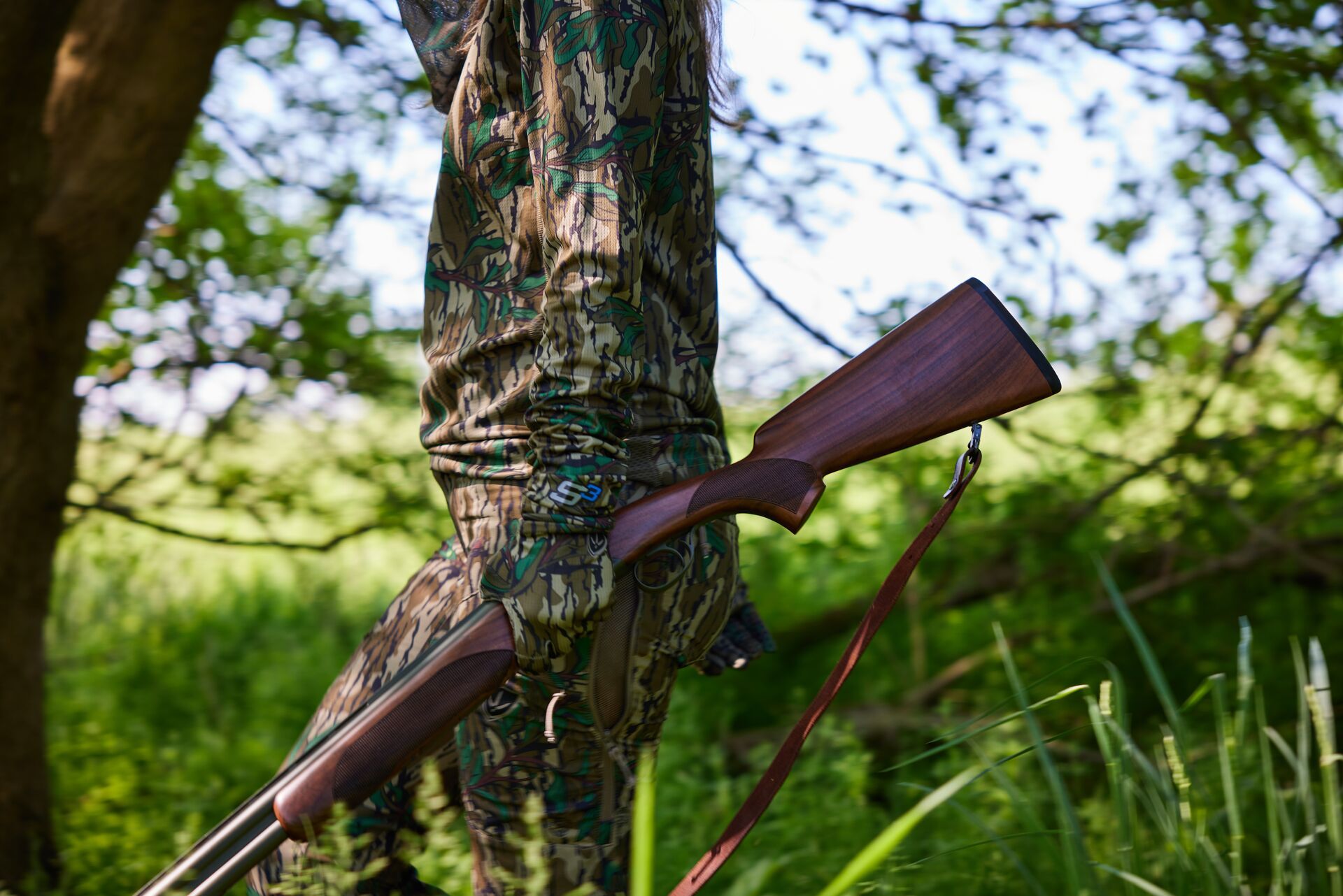 Close-up of a female hunter holding a rifle, hunting must-haves concept. 