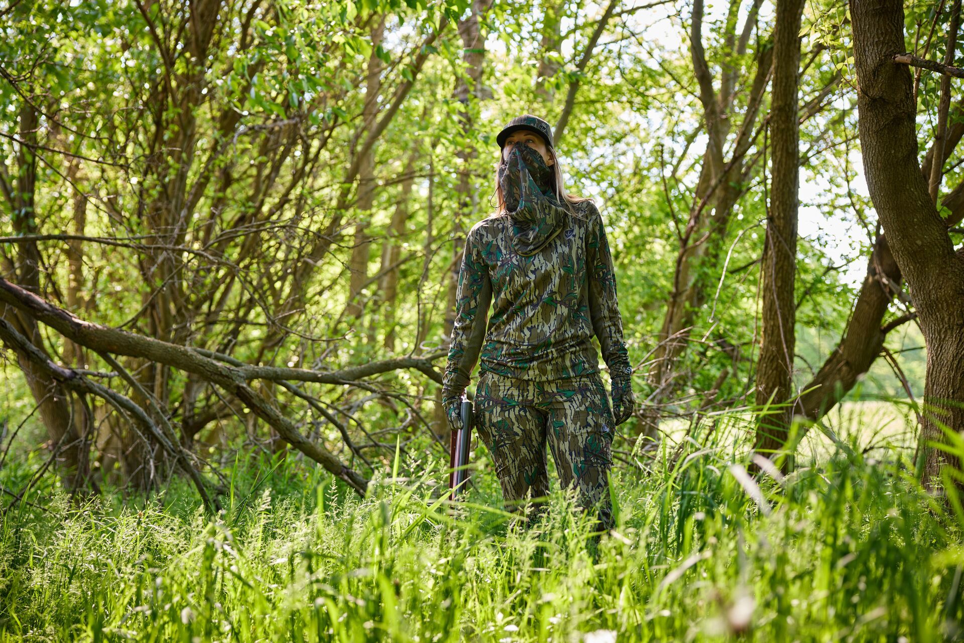 A woman dressed in camo in the field for hunting in Georgia.