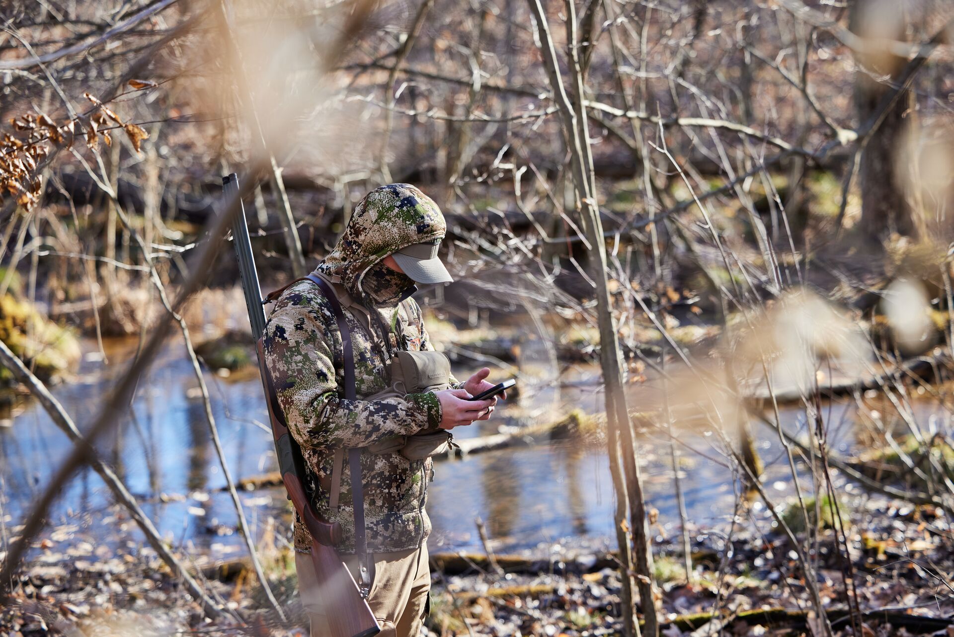 A hunter uses HuntWise in the field, scouting Wisconsin turkey zones concept. 