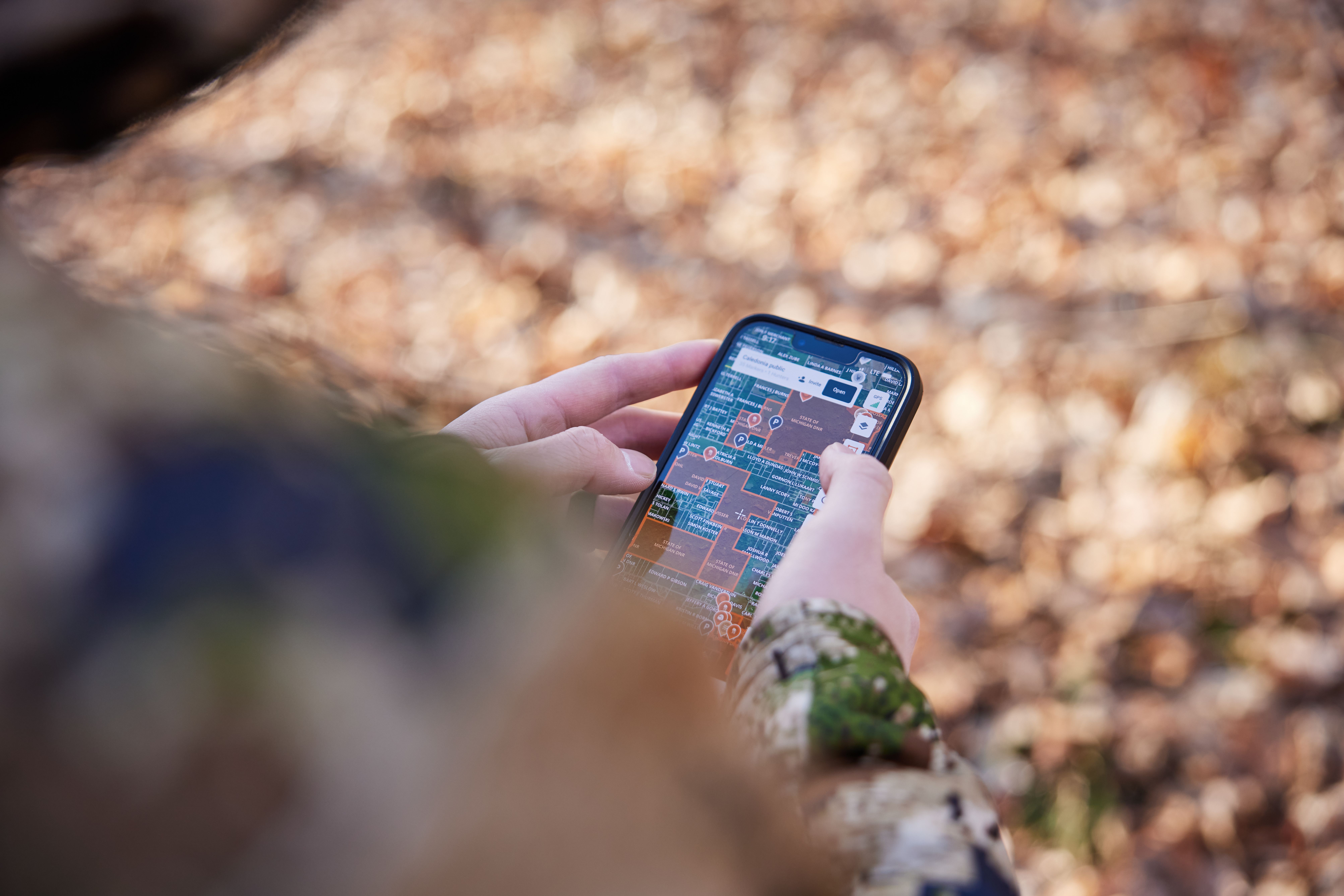 Close-up of someone using the HuntWise app, morel mushroom hunting concept. 