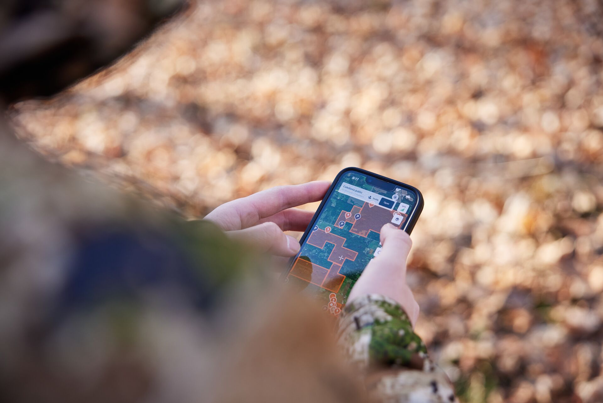 Close-up of a hunter using the HuntWise app, hunt in Kentucky concept.