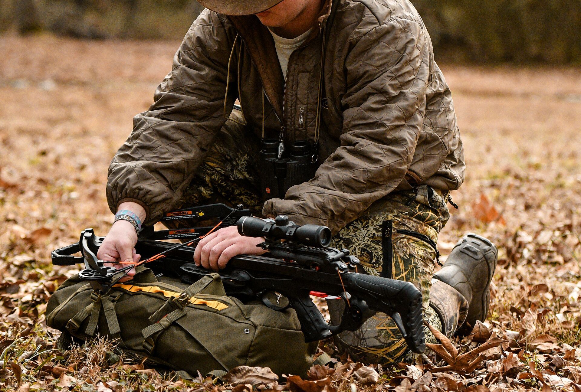 A hunter packing gear into a pack, preparing for deer season concept. 