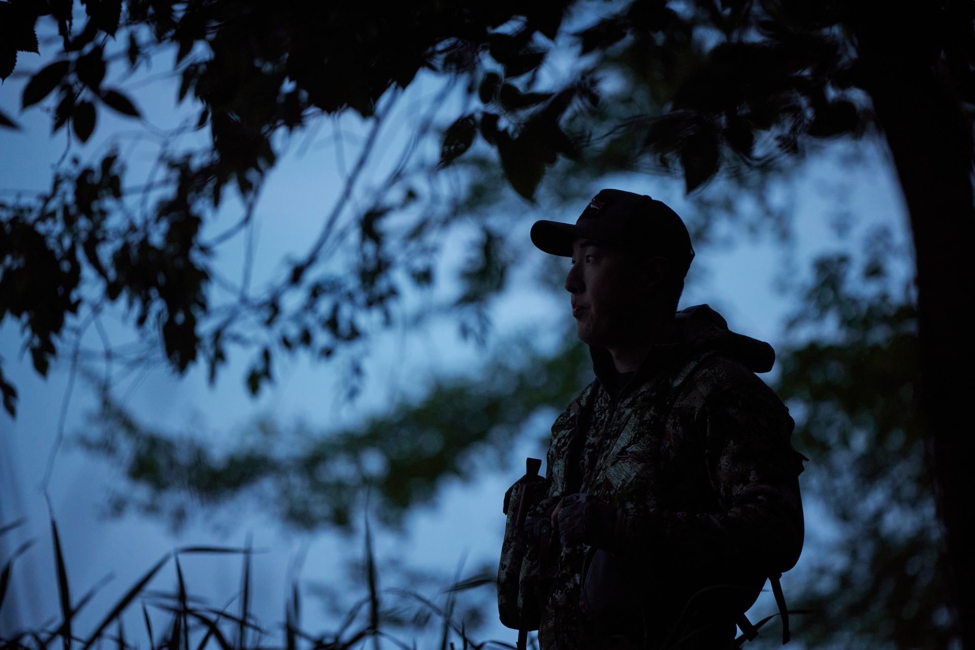 A hunter in the woods at night. 