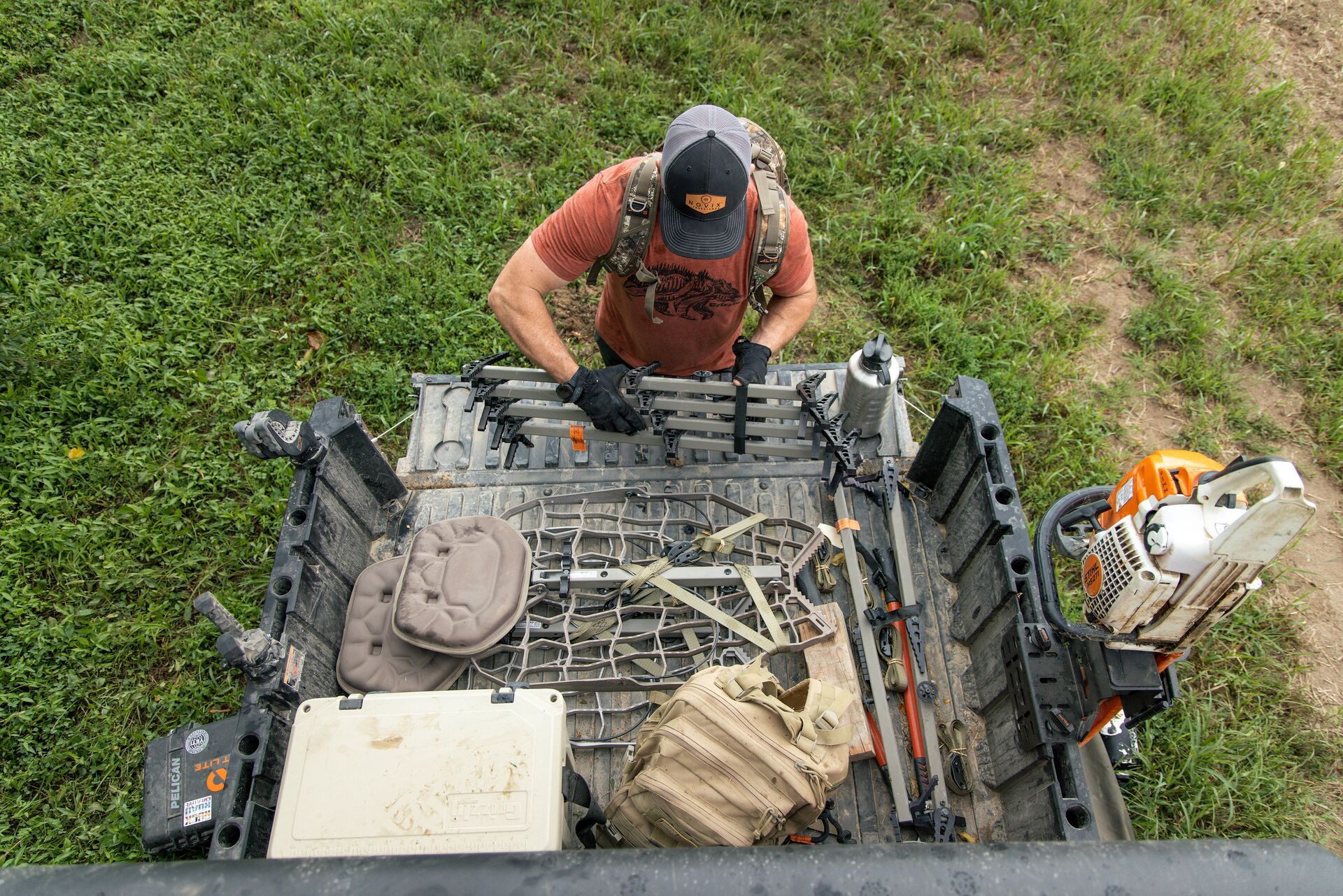 A hunter gathering treestand equipment. 