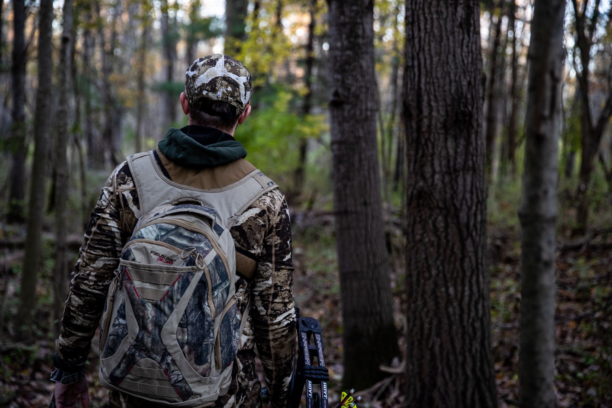 A hunter in the woods with essential hunting gear. 